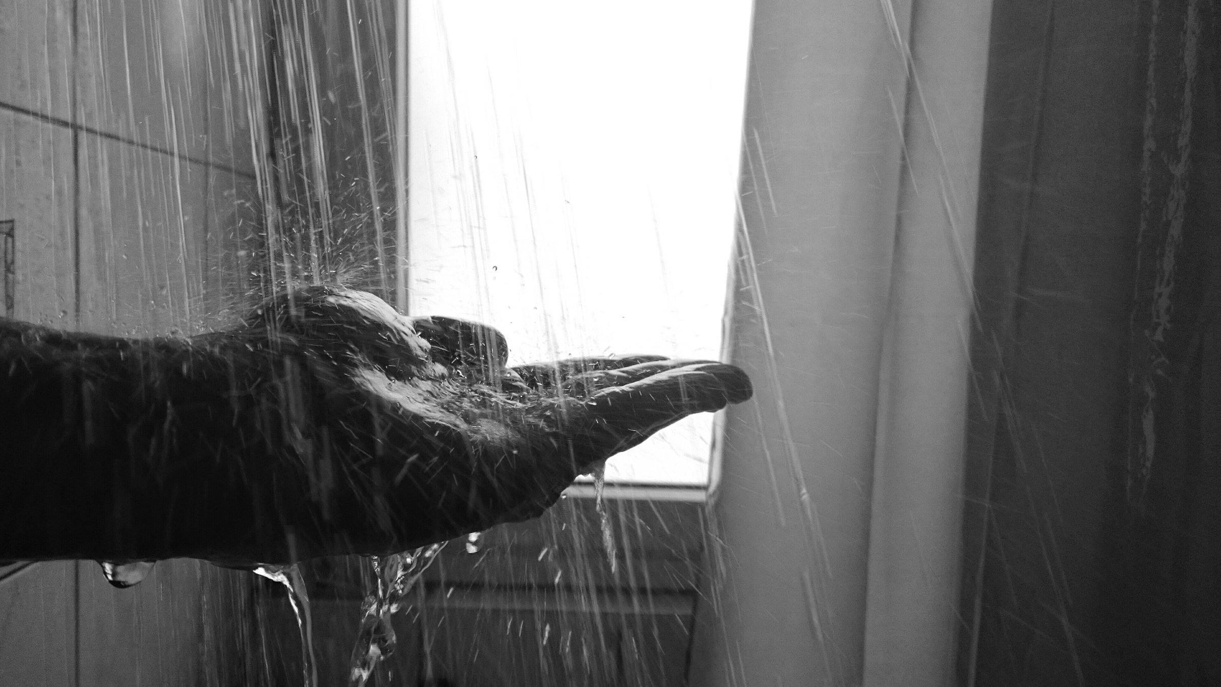 Cropped Image Of Person Hand Under Shower