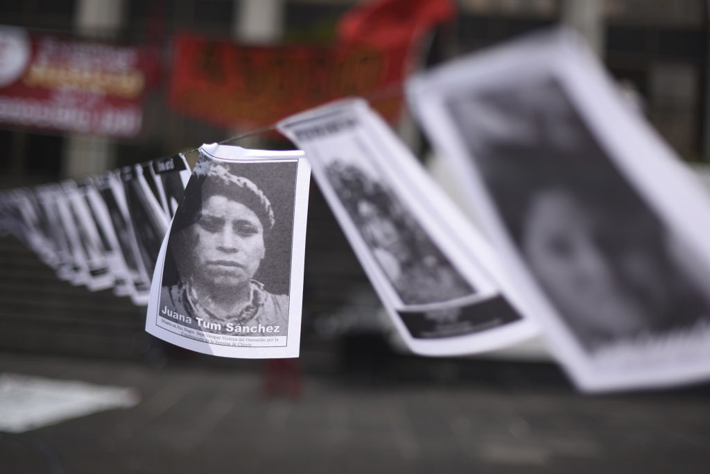 Portraits of missing persons within Guatemalan internal armed conflict, are displayed by human rights' organization "Hijos" during a protest at Justice square in Guatemala City on April 6 2018. (Johan Ordonez—AFP/Getty Images)