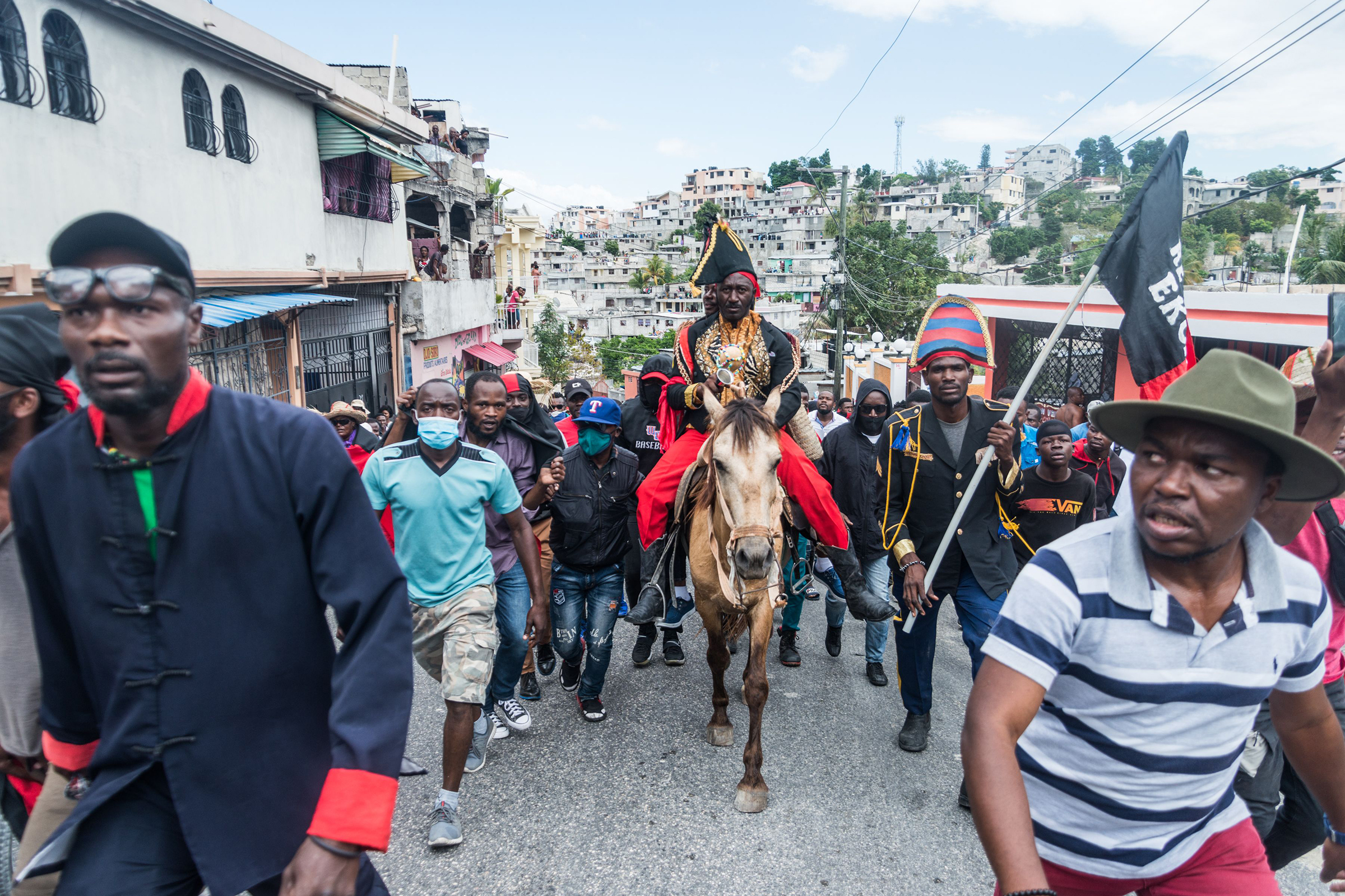 The leader of the "Pitit Desalin" party, Moise Jean Charles, rides a horse as Haitian protesters march through the streets to denounce the upsurge in kidnappings committed by gangs in Port-au-Prince, Haiti, on February 28, 2021. (Reginald Louissaint—AFP/Getty Images)