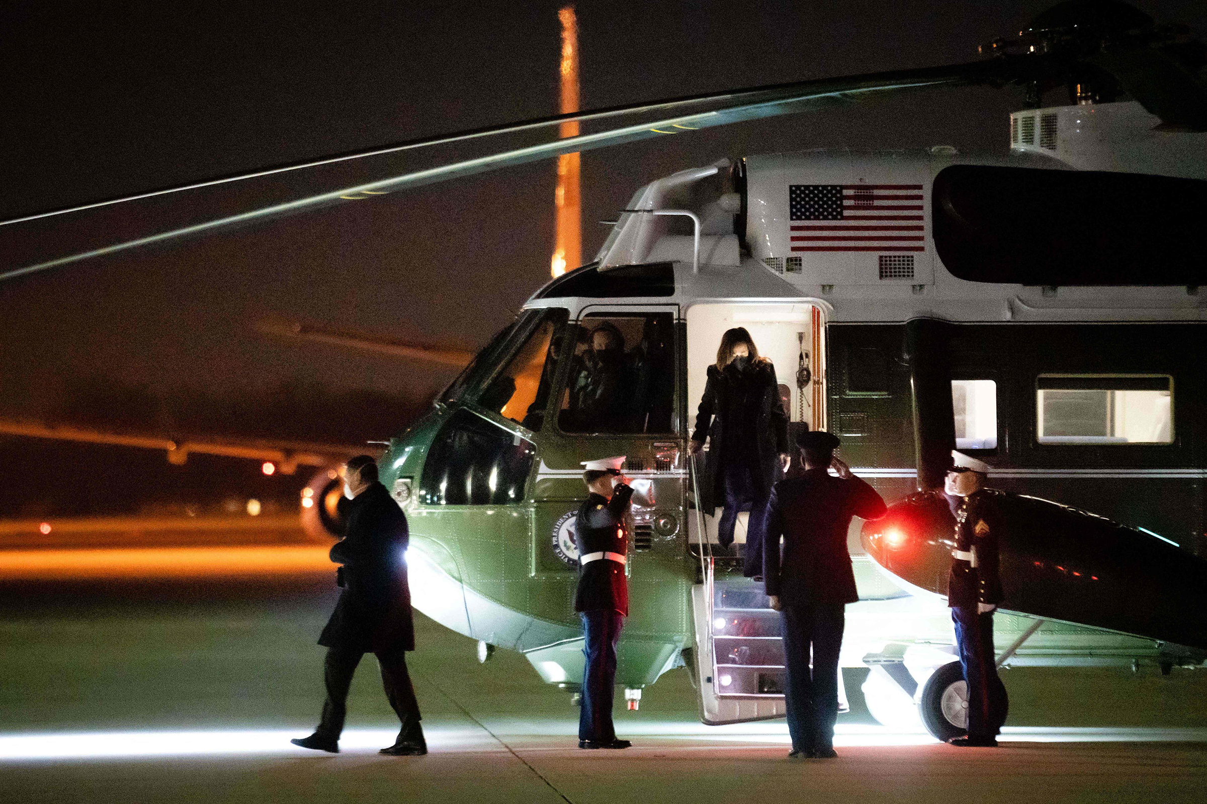 US Vice President Kamala Harris (C) walks off a helicopter to board Air Force Two for a trip to Honduras to attend the inauguration ceremony for Honduran President-elect Xiomara Castro, at Joint Base Andrews in Maryland early on January 27, 2022. (Erin Schaff—AFP/Getty Images)