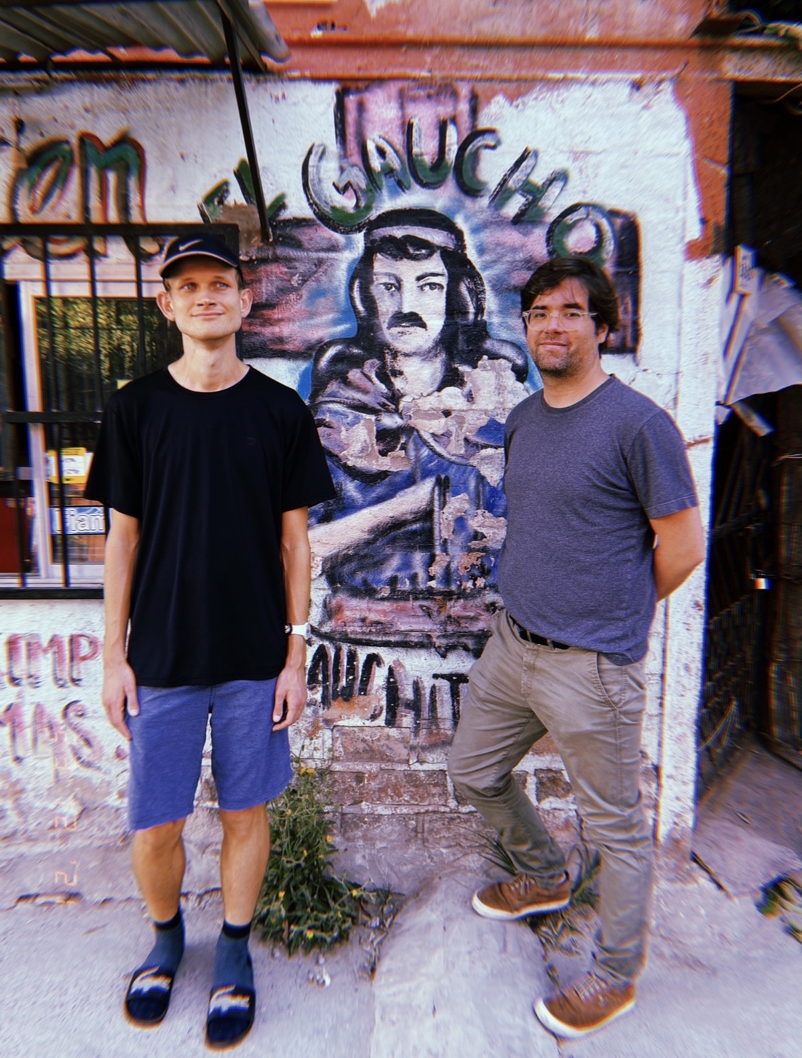 Santiago Siri a board member of Proof of Humanity, right, with Vitalik Buterin, the founder of Ethereum, in front of a mural in Argentina (Courtesy Ezequiel Churba)