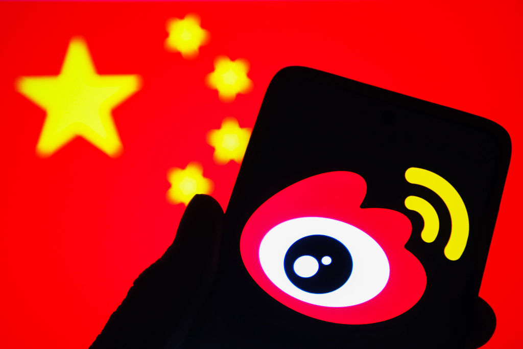 In this photo illustration, the logo of the Weibo (Sina