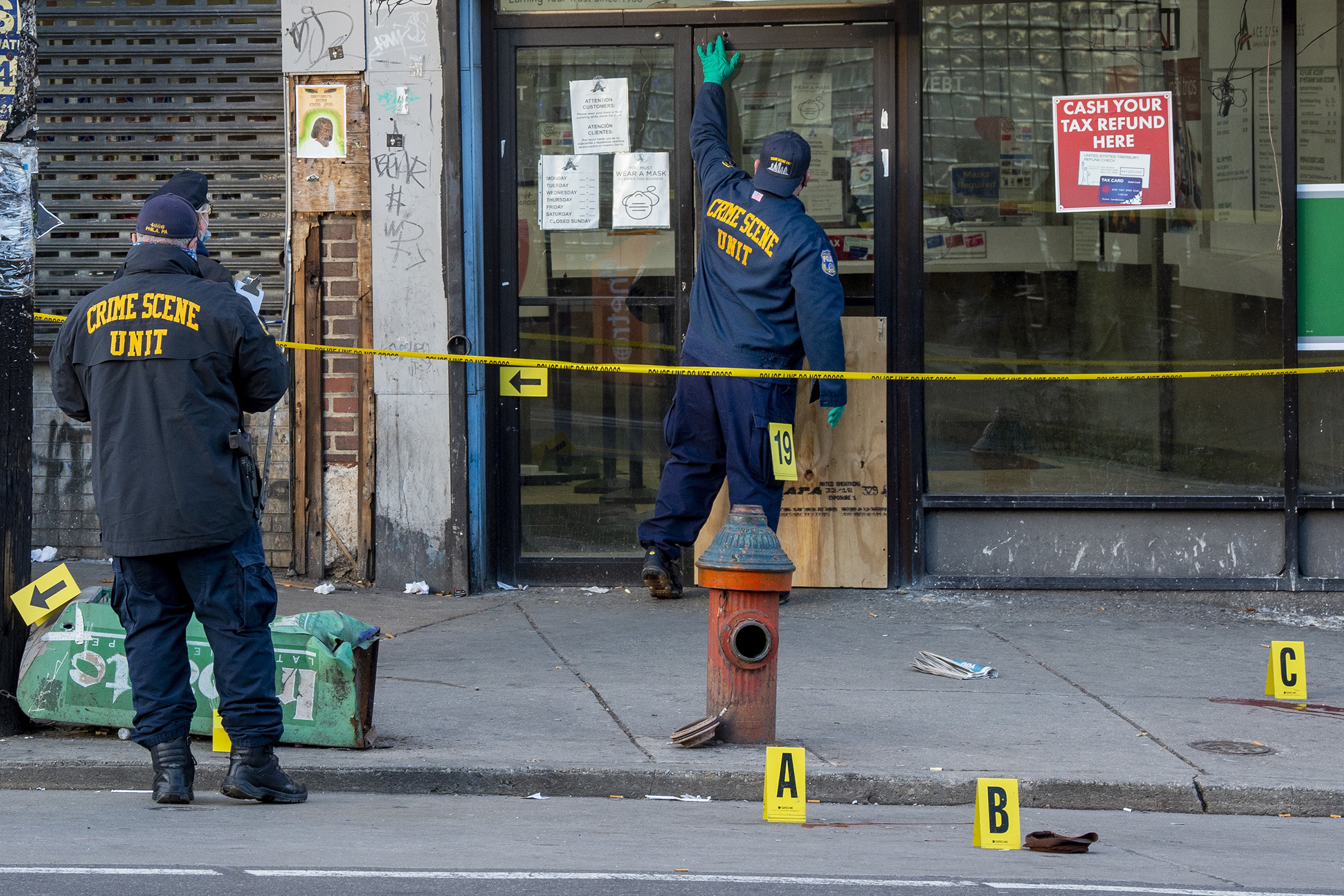 Police Crime Scene officers work outside the SEPTA Olney Transportation Center, Wednesday, Feb. 17, 2021 after at least eight people were wounded by gunfire. (Tom Gralish—The Philadelphia Inquirer/AP)
