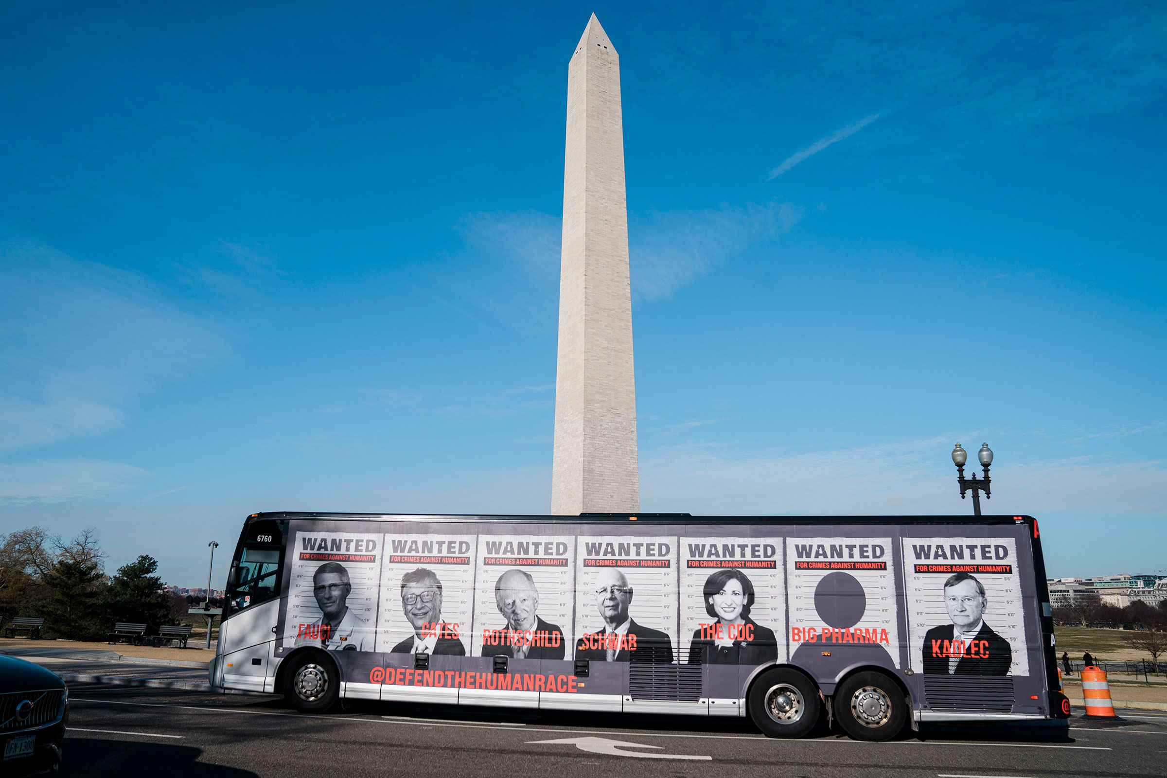 A bus with photos of prominent scientific and tech community members is seen ahead of a Defeat the Mandates march in Washington. (Kent Nishimura—Los Angeles Times/Getty Images)