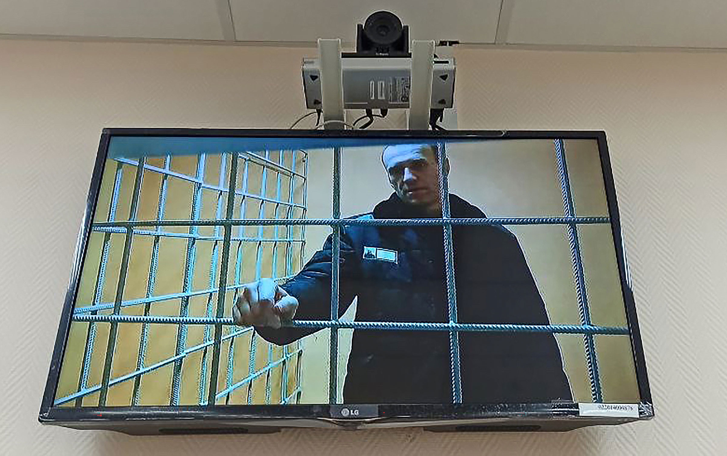 Russian opposition activist Alexei Navalny is seen on the screen during a hearing at the Petushki District Court on January 17, 2022. (Anna Ustinova—TASS/Getty Images)