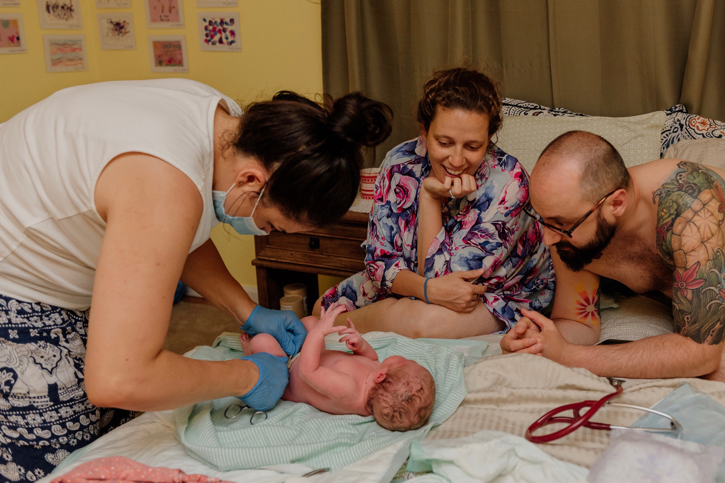 Photo courtesy of Caryn Davis (From left: Nuranisa Rae, a midwife; baby Caily; Caryn Davis; and Brian Davis)