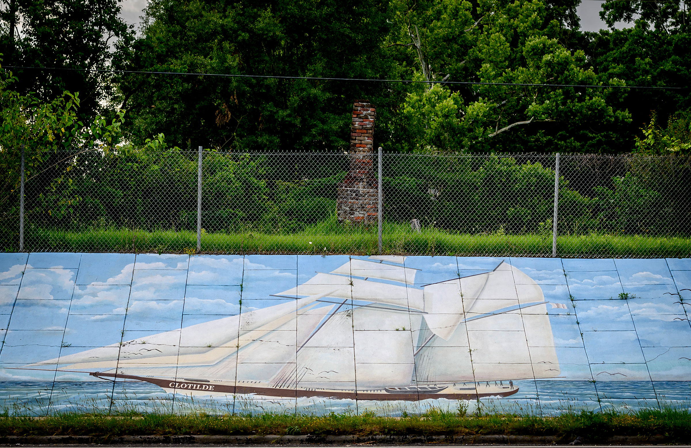 A mural depicting the schooner Clotilda, which carried the last cargo of enslaved Africans known to have been delivered to the United States, in Mobile, Ala.