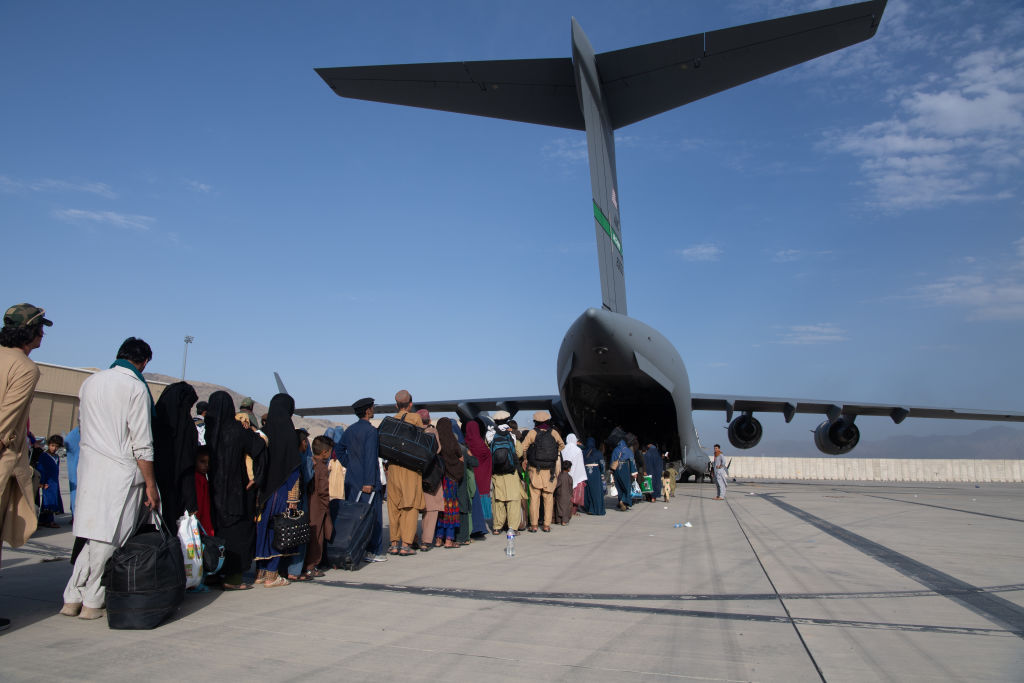 In this handout provided by U.S. Central Command Public Affairs, U.S. Air Force loadmasters and pilots assigned to the 816th Expeditionary Airlift Squadron, load passengers aboard a U.S. Air Force C-17 Globemaster III in support of the Afghanistan evacuation at Hamid Karzai International Airport (HKIA) on August 24, 2021 in Kabul, Afghanistan. (Master Sgt. Donald R. Allen—U.S. Air Forces Europe-Africa/Getty Images)