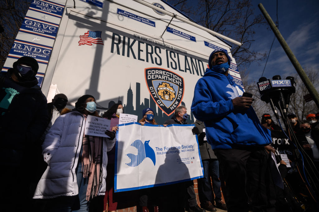 Protesters attend a rally held in solidarity with inmates on hunger strike, at the entrance to the Rikers Island jail complex in Queens, New York on January 13, 2022. Alongside other criminal justice proposals, Mayor Eric Adams calls for a law to be implemented where judges are allowed to take a defendant's "dangerousness" into account when deciding on if bail is to be offered. (Ed Jones—Getty Images)