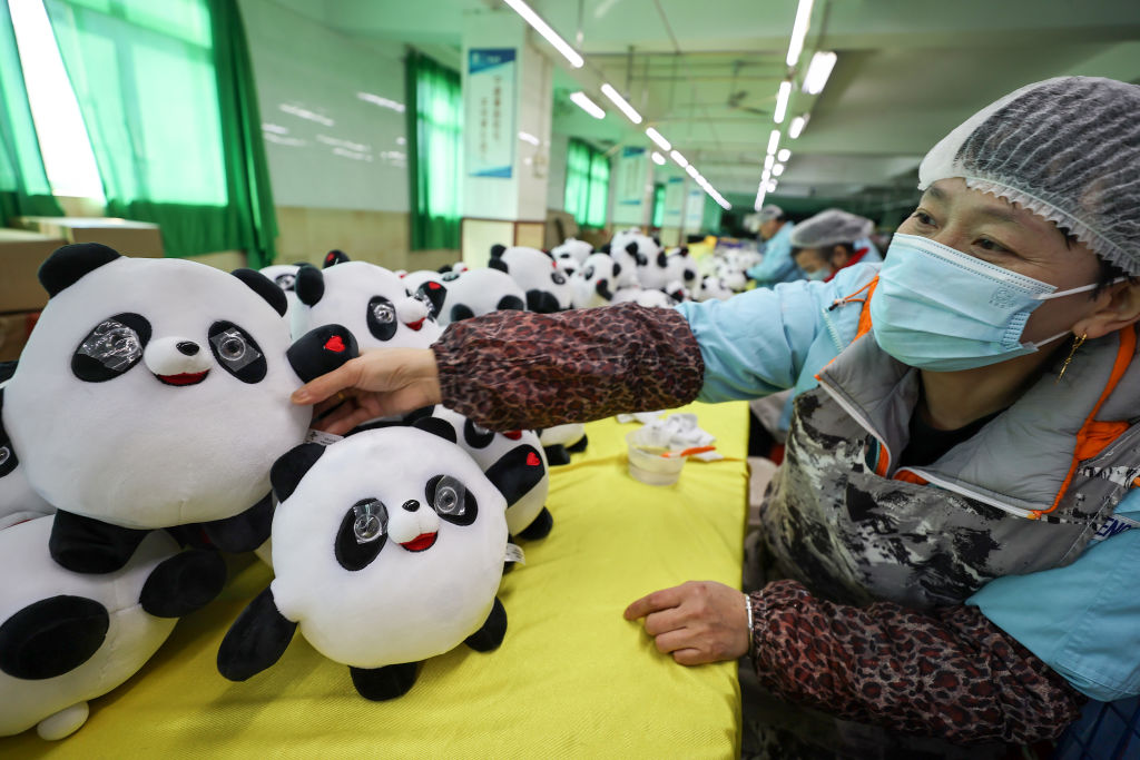People work in a factory making Bing Dwen Dwen, the mascot of 2022 Beijing Winter Olympics, in Jinjiang city in southeast China's Fujian province Tuesday, Feb. 08, 2022. (YUAN HE/Future Publishing via Getty Images)