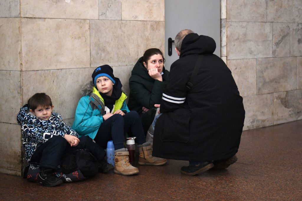 A family takes shelter in a metro station in Kyiv in the morning of Feb. 24, 2022. (DANIEL LEAL/AFP via Getty Images)