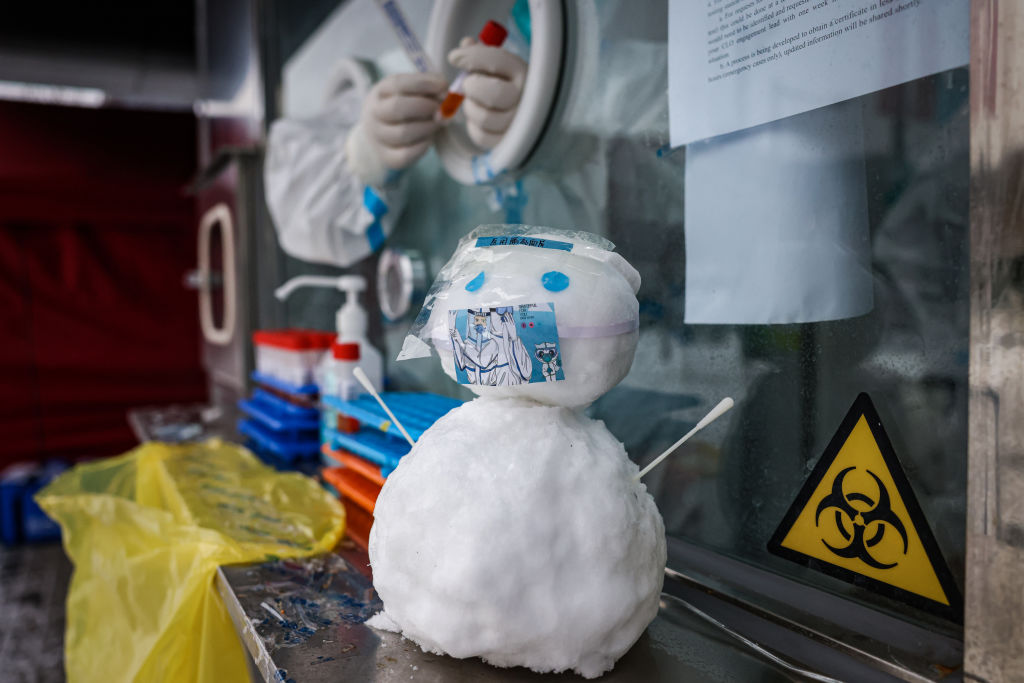 A snowman seen wearing a face mask at an COVID testing booth on February 13, 2022 in Beijing, China. (Annice Lyn/Getty Images)