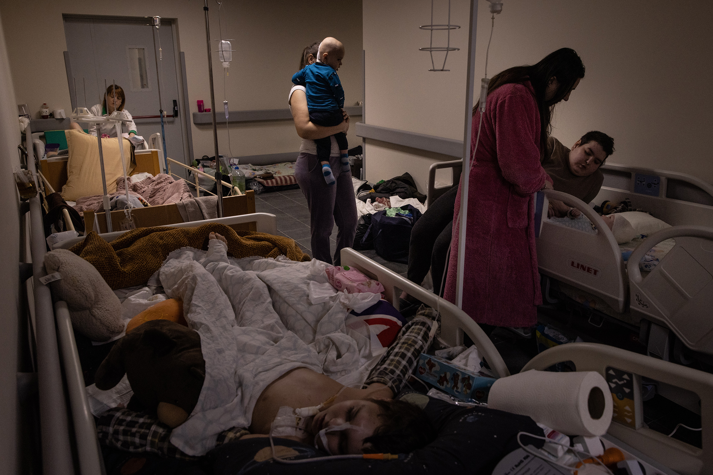 Mothers tend to their children who are undergoing cancer treatment in the bomb shelter of the Oncology ward at Okhmatdyt Children's Hospital on Feb. 28 in Kyiv (Chris McGrath—Getty Images)