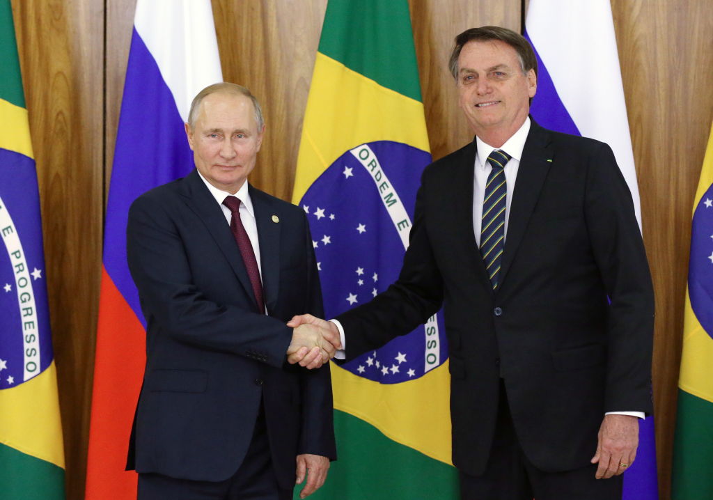 Russia's President Vladimir Putin and Brazil's President Jair Bolsonaro shake hands during a meeting at the Planalto Palace on Nov. 14, 2019. (Konstantin Zavrazhin—TASS/Getty Images)