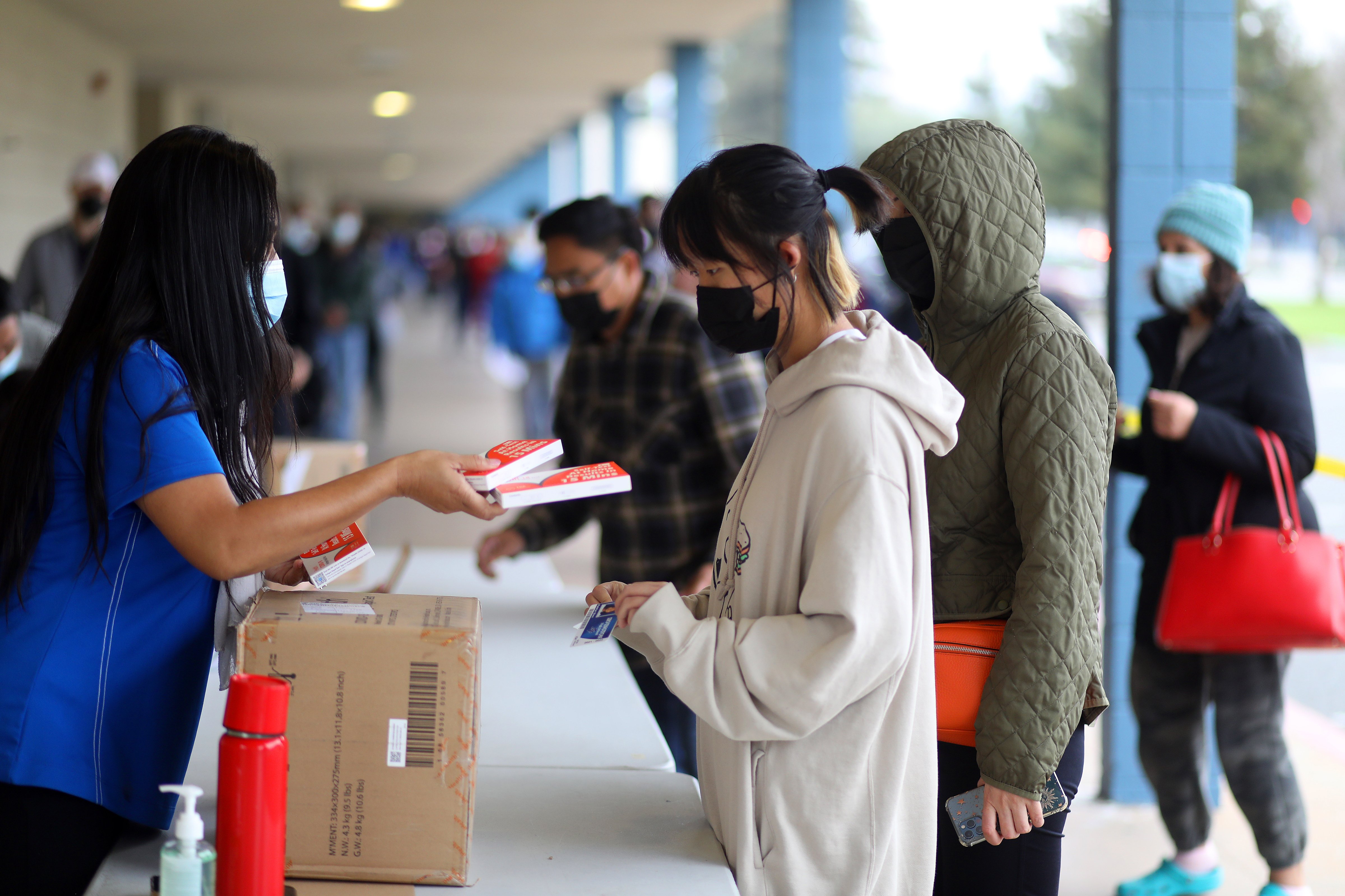 Fremont Unified School District staff members distribute COVID-19 rapid tests to students at Irvington High School on Jan. 6, 2022, in Fremont, Calif. (Aric Crabb—MediaNews Group/Getty Images)