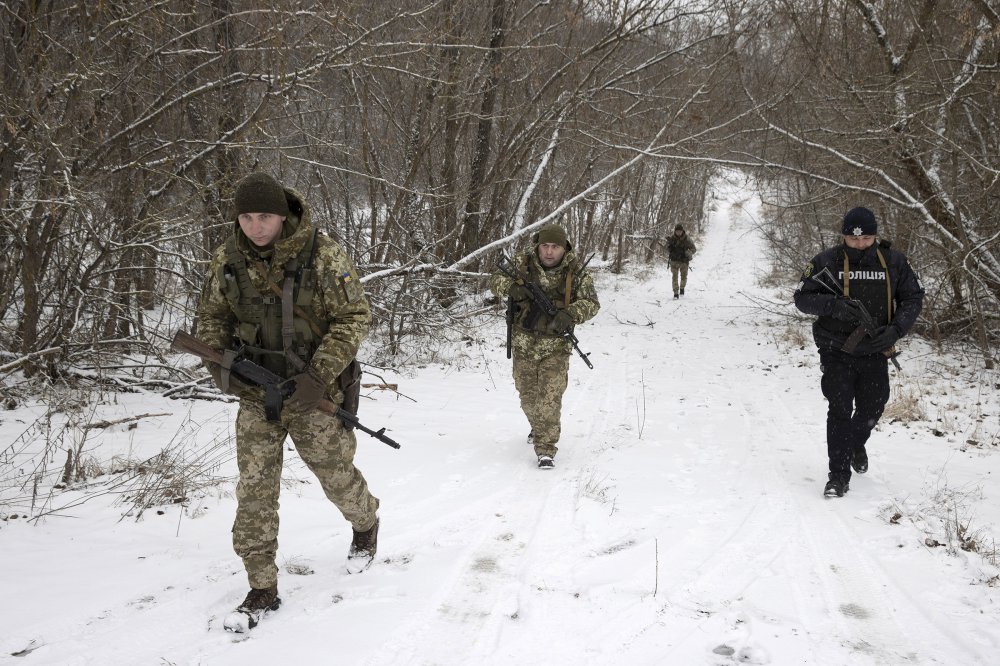 Ukrainian border guards on a joint patrol Jan. 9, 2022, near the border with Belarus. (Tyler Hicks/The New York Times)