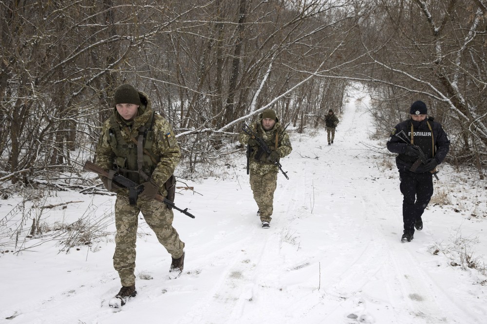 Ukrainian border guards on a joint patrol Jan. 9, 2022, near the border with Belarus. (Tyler Hicks/The New York Times)