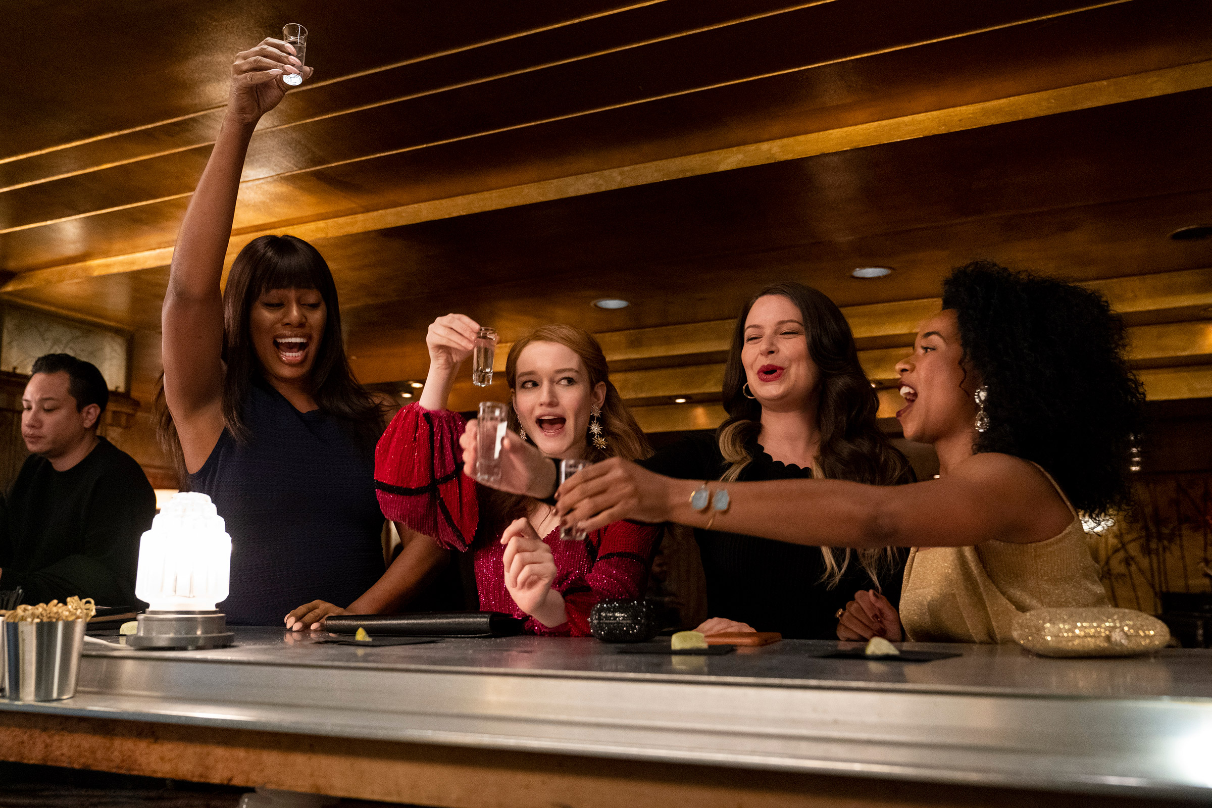 'Inventing Anna' stars Julia Garner as Anna Sorokin (second from left), with Laverne Cox (far left), Katie Lowes (center right) and Alexis Floyd (far right) as real-life women whom Sorokin befriended. (Aaron Epstein—Netflix)