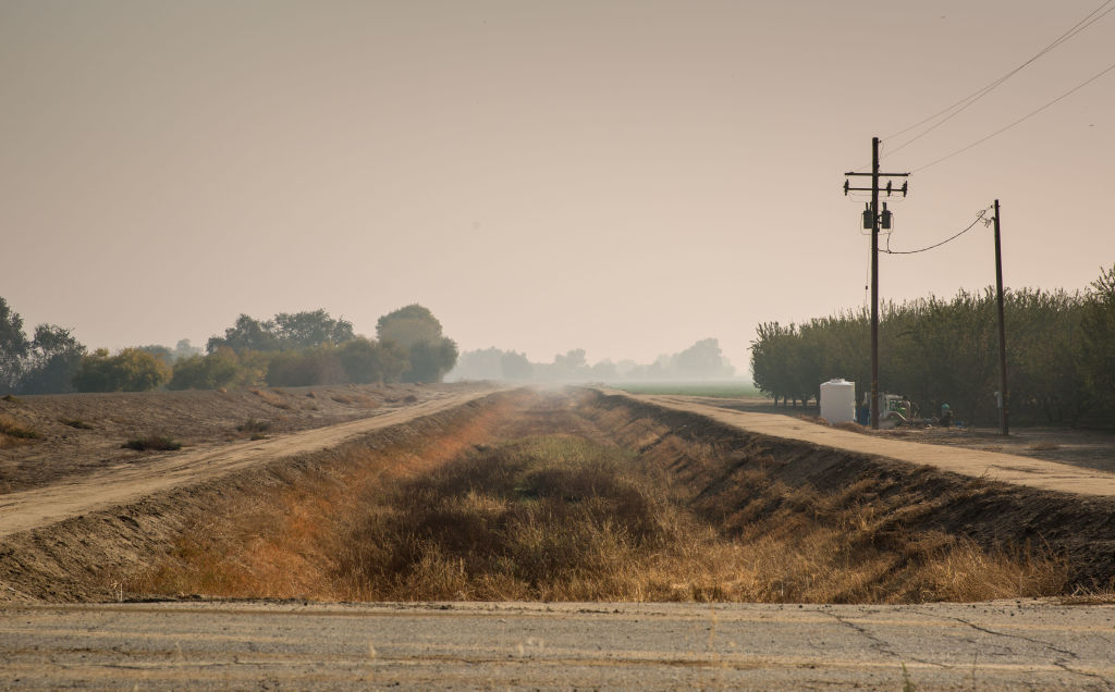 A dry agricultural irrigation canal along Highway 41 is viewed on Oct. 29, 2021, near Stratford, in California's Central Valley, which produces much of the U.S. food supply. Due to extreme water shortages, the U.S. federal government recently announced it would not be delivering water to the region. (George Rose—Getty Images)