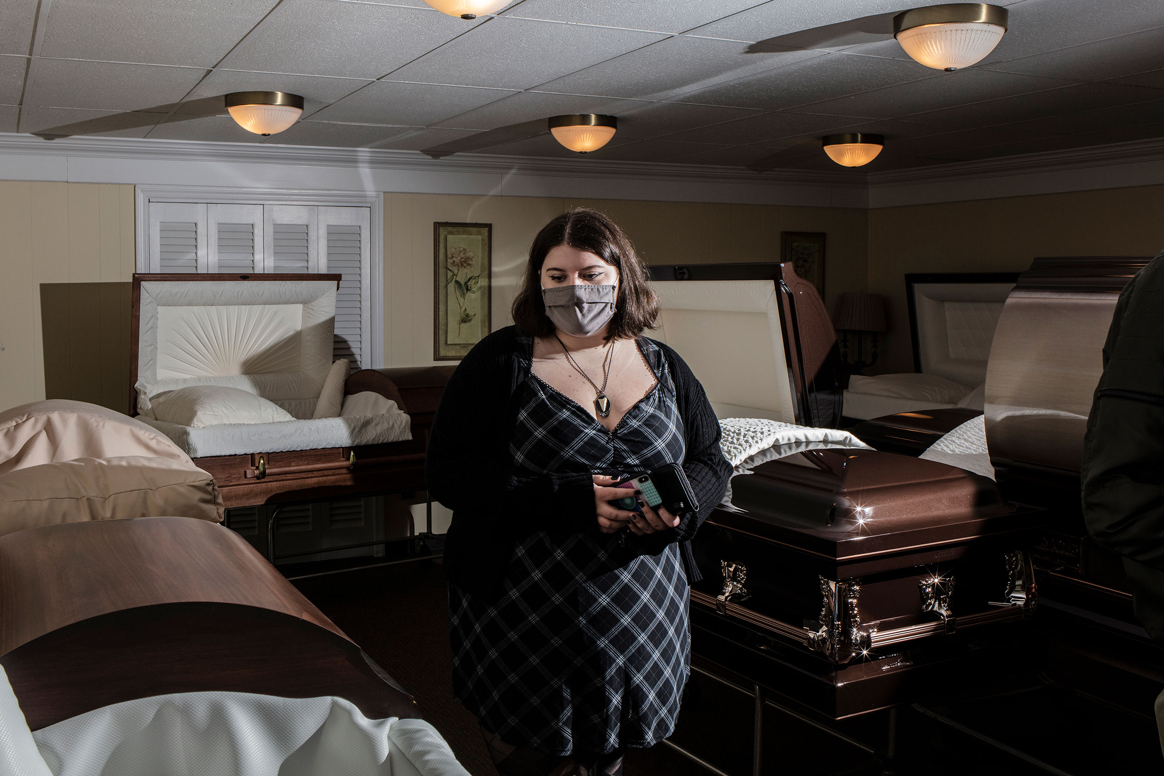 A student examines a casket during a Kean University course on death at Galante Funeral Home. (Bryan Anselm for TIME)
