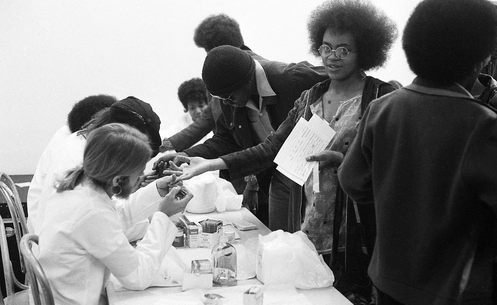 The Black Panthers put on a Black Community Survival Conference at the Civic Auditorium in Oakland, Calif. on March 29, 1972. Participants could take sickle cell anemia tests, register to vote, and receive bags of groceries. (Dave Randolph—The San Francisco Chronicle/Getty Images)
