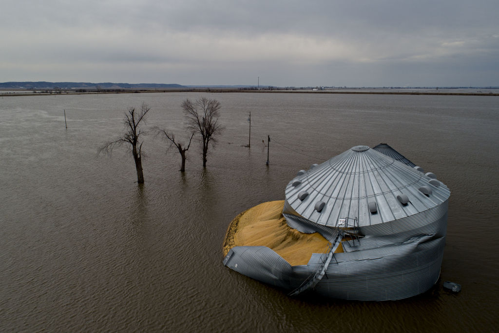 Floodwaters surround corn sitting under a collapsed grain bin in Thurman, Iowa,  on Saturday, March 23, 2019. (Daniel Acker/Bloomberg—Getty Images)