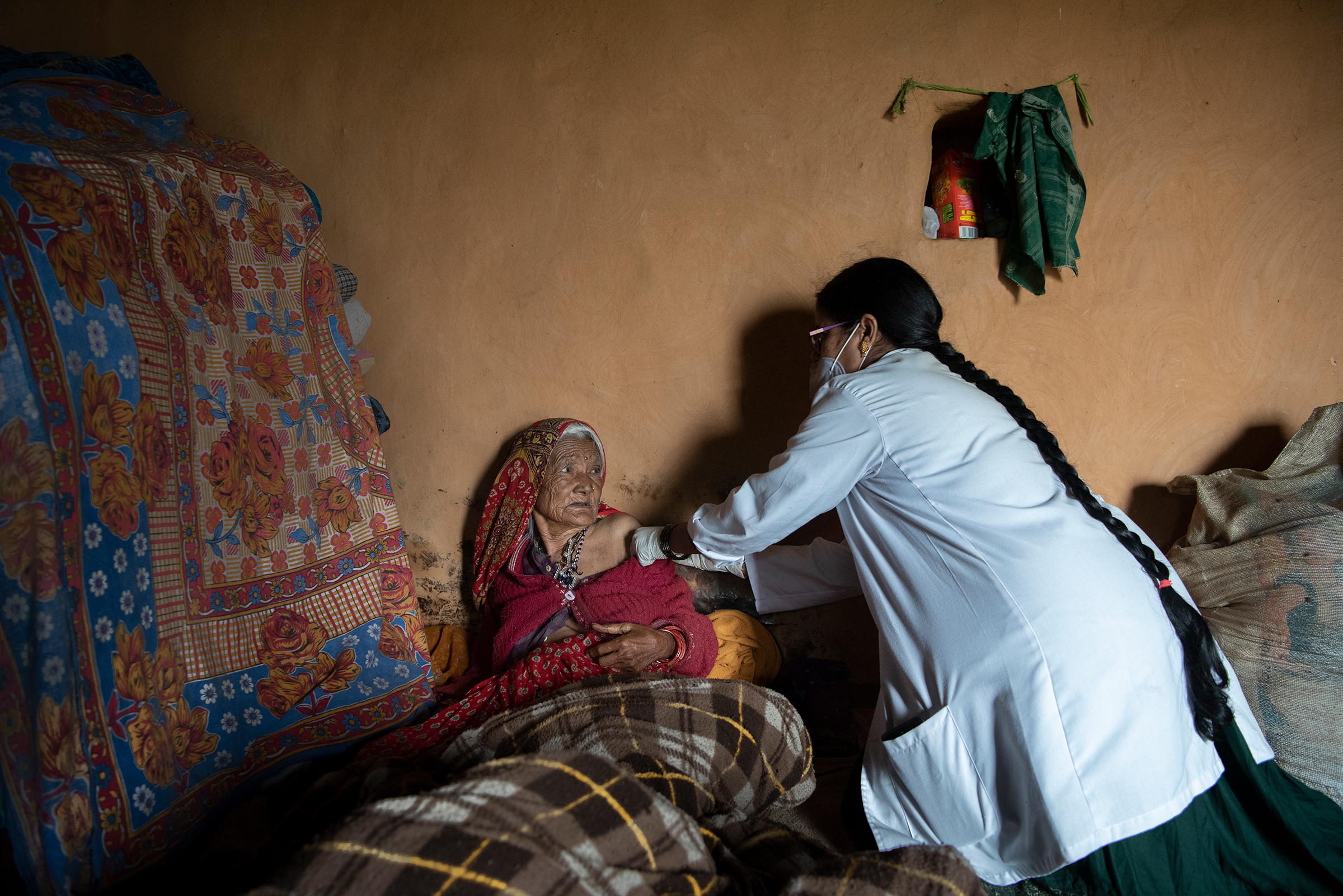 Gokuli Devi, 80, receives a vaccine at her home near Aghariya, India, on Sept. 4 because she is too frail to walk to a local site