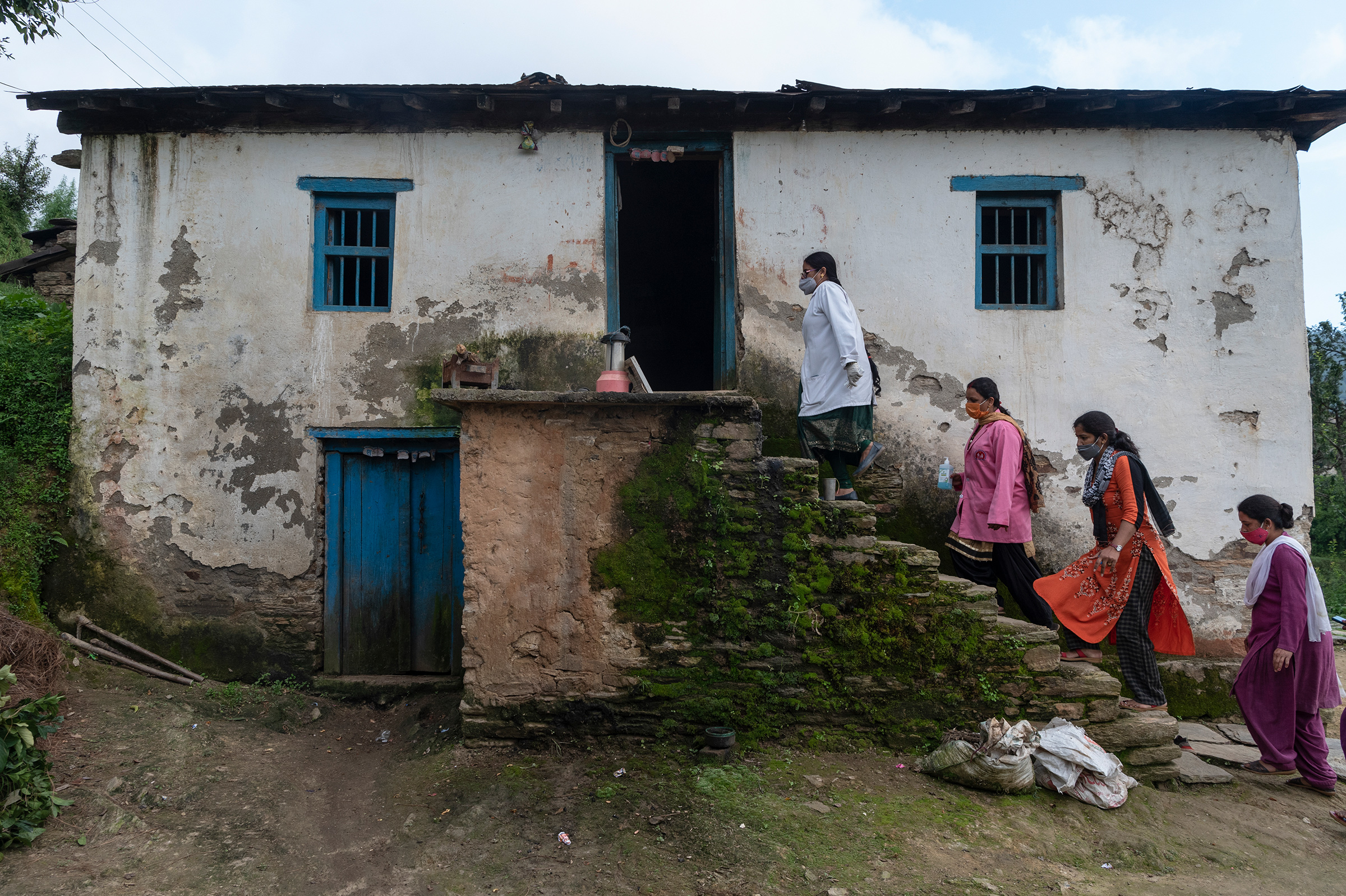 A mobile team led by Sharma, left, visits the home of a local who cannot make it to a vaccination center (Saumya Khandelwal for TIME)