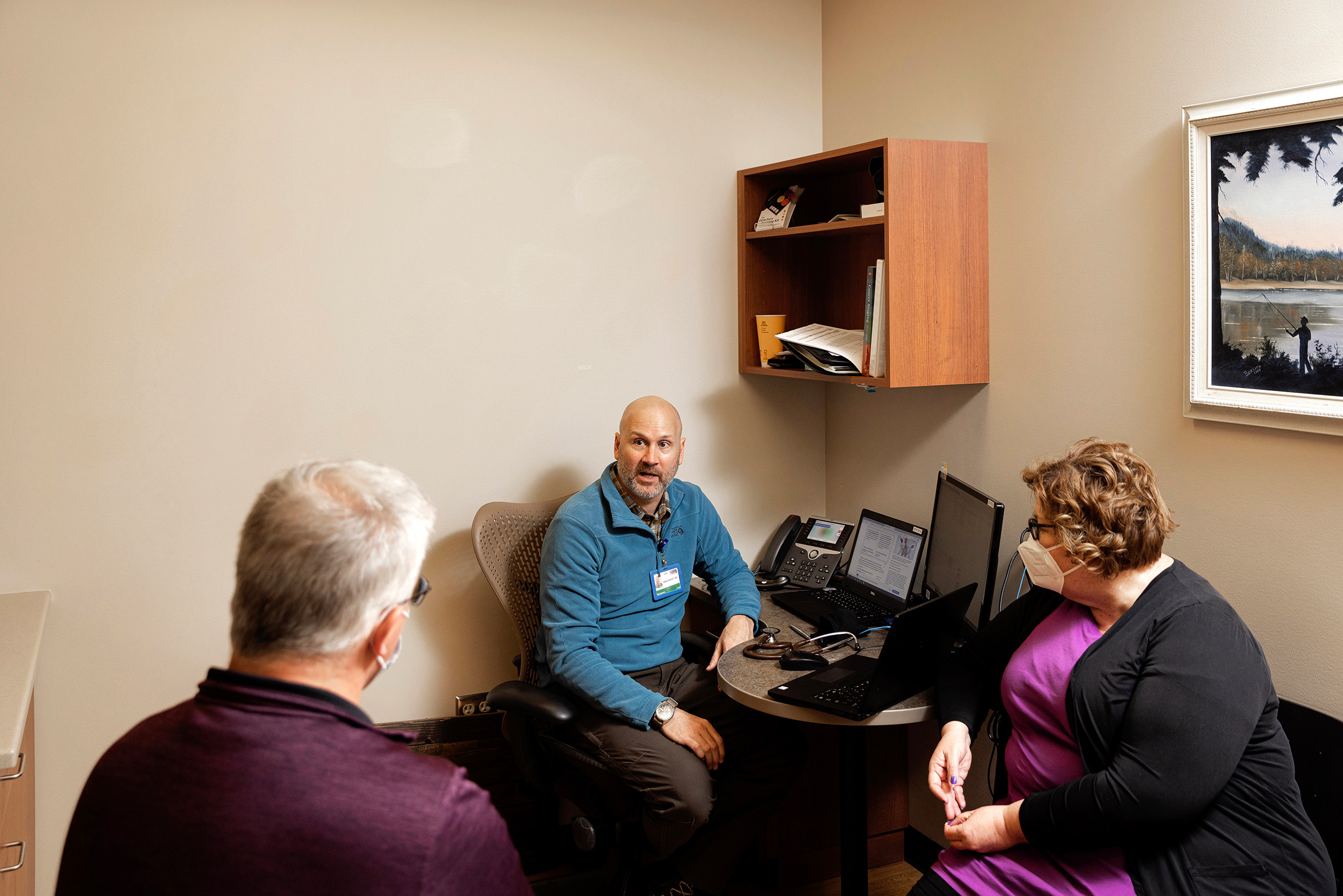 Dr. Brad Nieset talks with Mike and Amber Rausch after completing testing for Long COVID symptoms (Rebecca Stumpf for TIME)