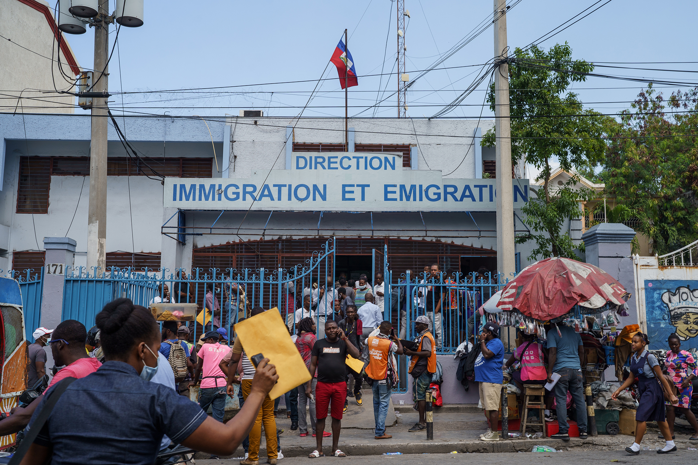 People gather in front of a busy immigration office in Port-au-Prince on Jan. 24.