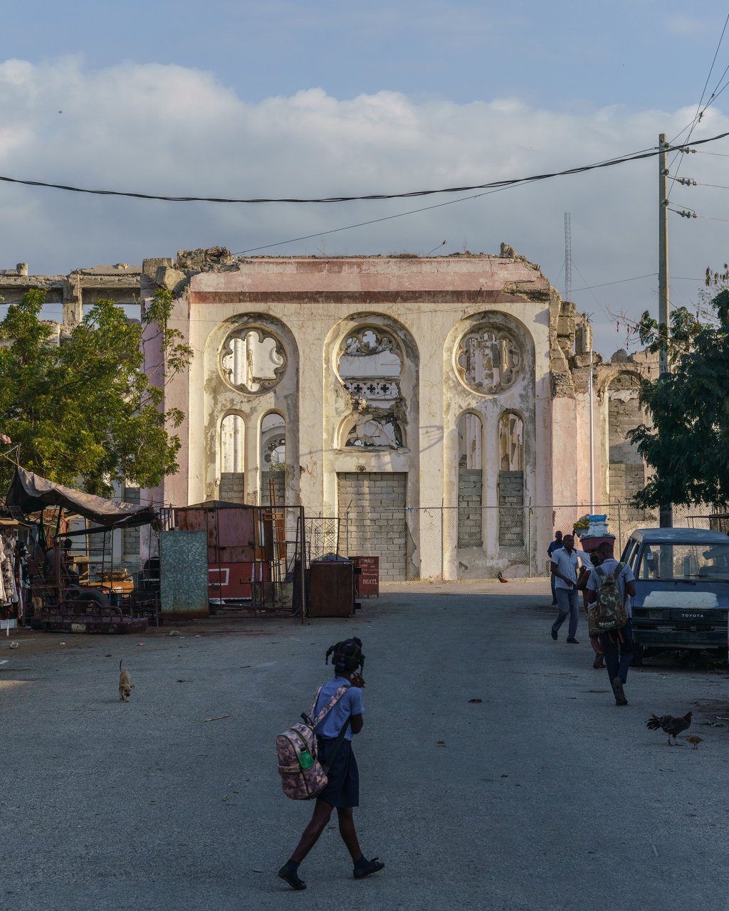 A young girl walks in front of the ruins of the Notre-Dame Cathedral, which was damaged in the 2010 earthquake, in downtown Port-au-Prince, Haiti on Monday January 24, 2022.