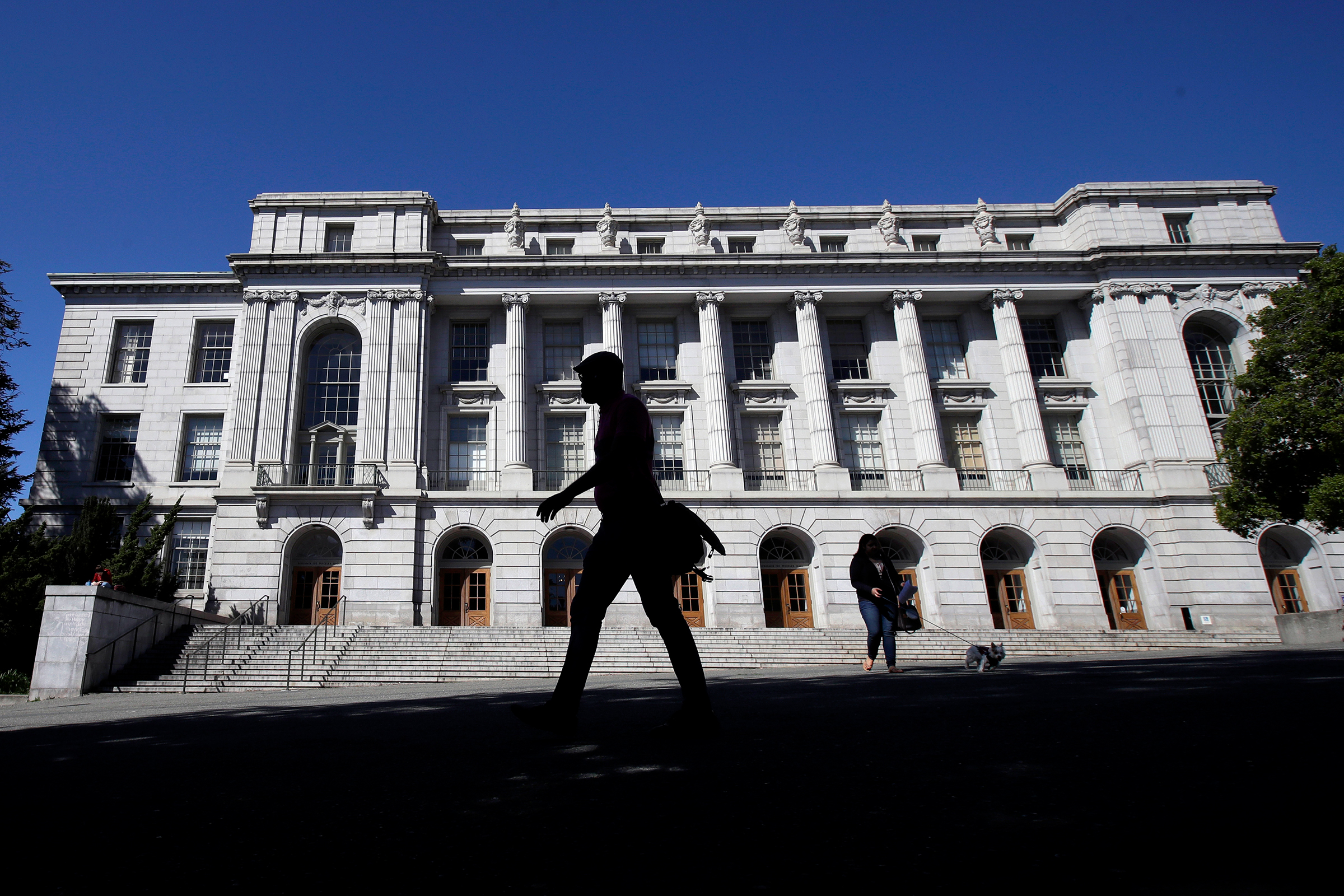 People walk in front of Wheeler Hall on the University of California campus in Berkeley, Calif., on March 11, 2020. (Jeff Chiu—AP)