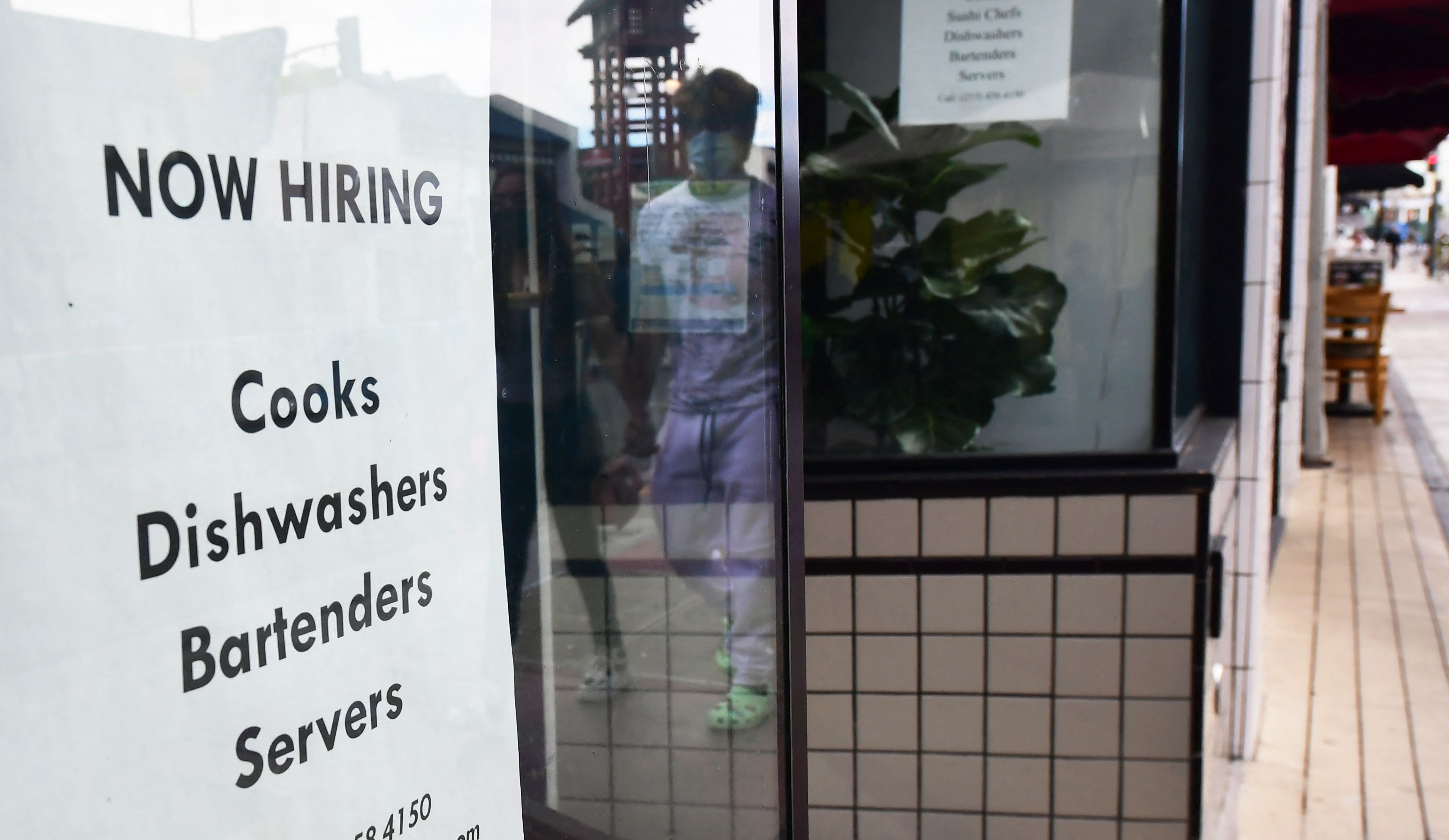 A "now hiring" sign is posted in the window of a restaurant in Los Angeles, California on January 28, 2022. (Frederic J. BROWN / AFP / Getty Images)