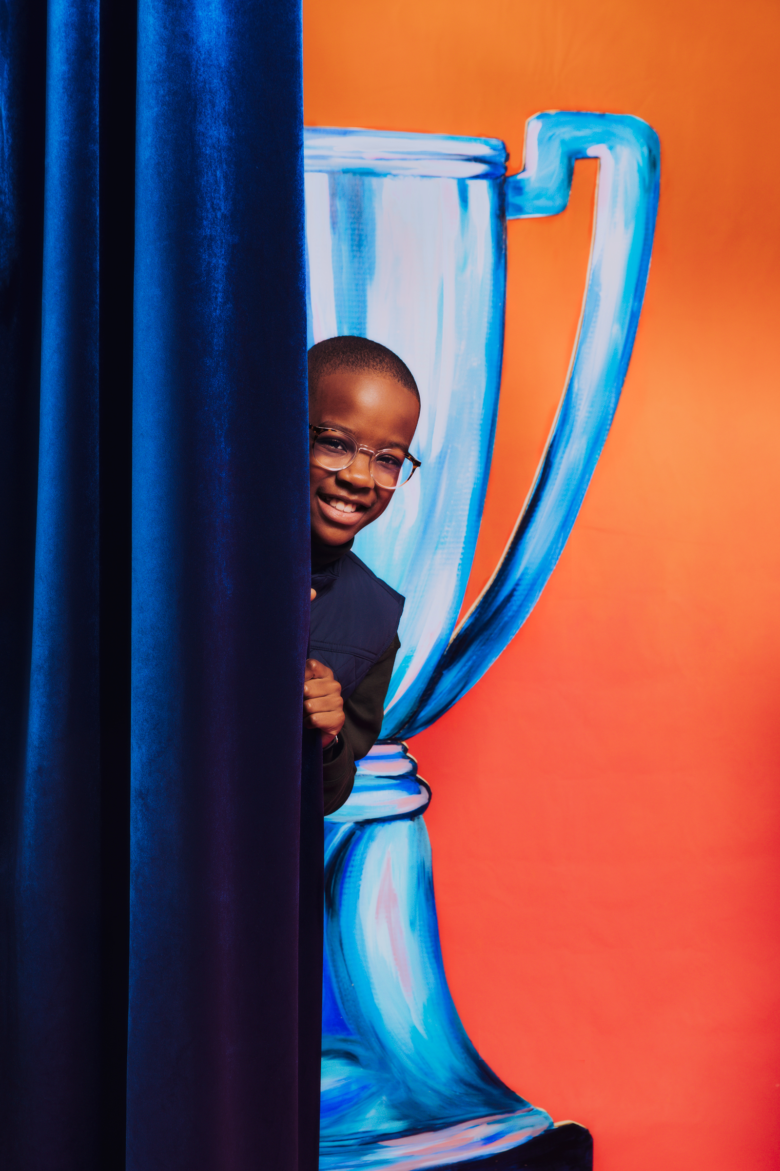 Orion Jean playfully hides behind the curtains on set on December 16, 2021. (Justin J Wee for TIME)