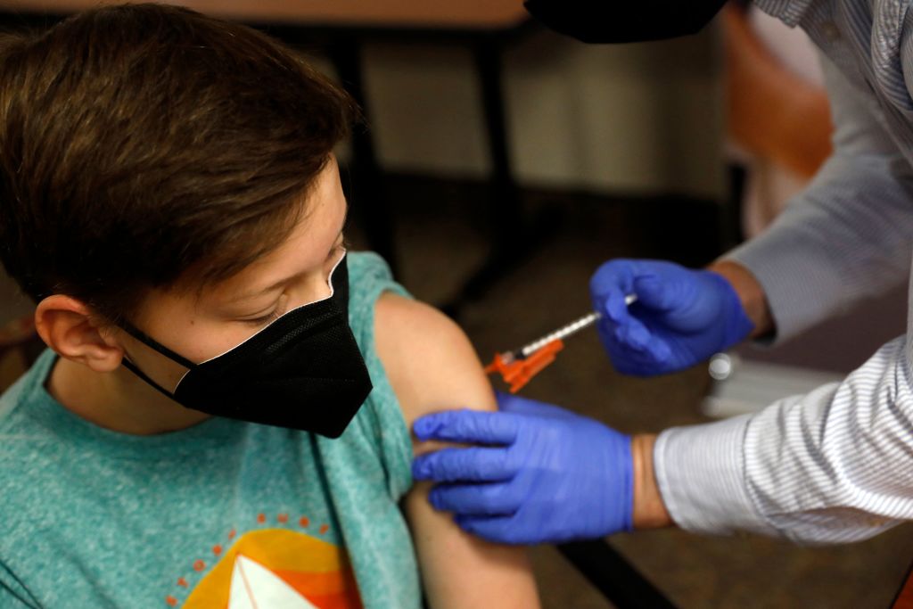 A child receives the Pfizer-BioNTech COVID-19 Vaccine at the Jewish Federation's offices in Bloomfield Hills, Mich., on May 13, 2021. (Jeff Kowalsky/AFP—Getty Images)