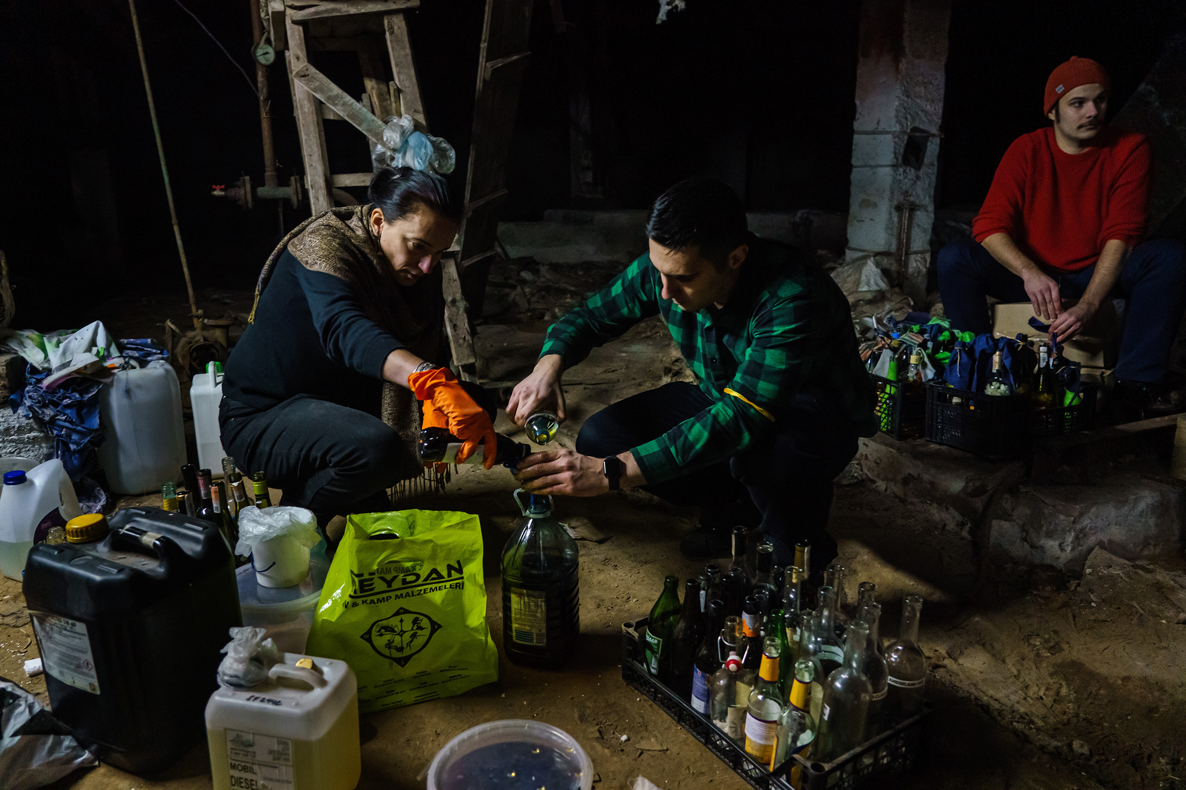 Volunteers from the Territorial Defense Force make Molotov cocktails to use against the invading Russian troops in Kyiv Feb. 26 (Marcus Yam—Los Angeles Times/Getty Images)
