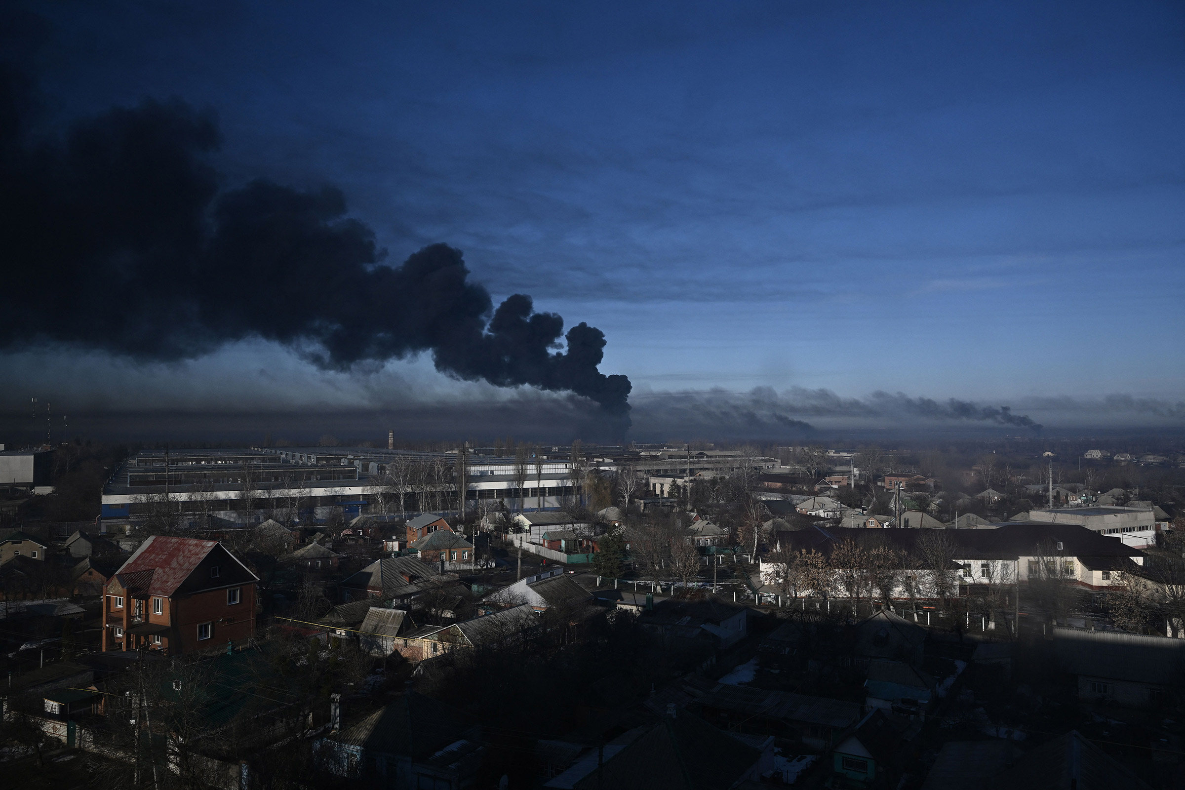 Black smoke rises from a military airport in Chuhuiv near Kharkiv on Feb. 24, 2022. (Aris Messinis—AFP/Getty Images)