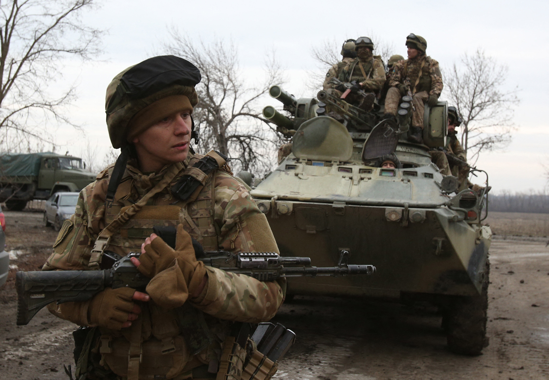 Ukrainian servicemen get ready to repel an attack in Ukraine's Lugansk region on Feb. 24.