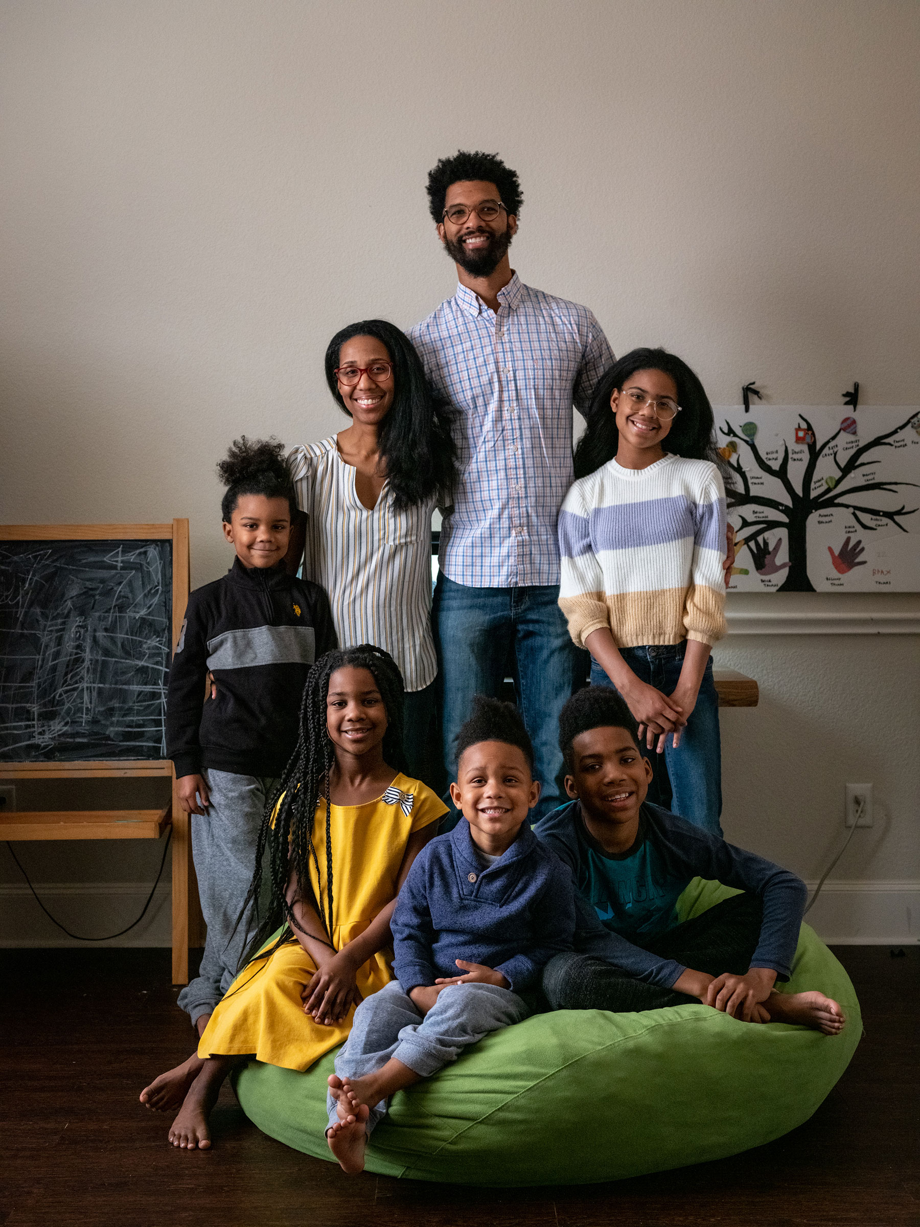 RICHARDSON, TEXAS - February 23, 2022: The Thomas family poses for a portrait in their home in Richardson, Texas. (Clockwise from left: Brax, 6; Andrea; Brian; Brea, 12; Brice, 10; Blaine, 4; and Bellamy, 8). Ilana Panich-Linsman for TIME