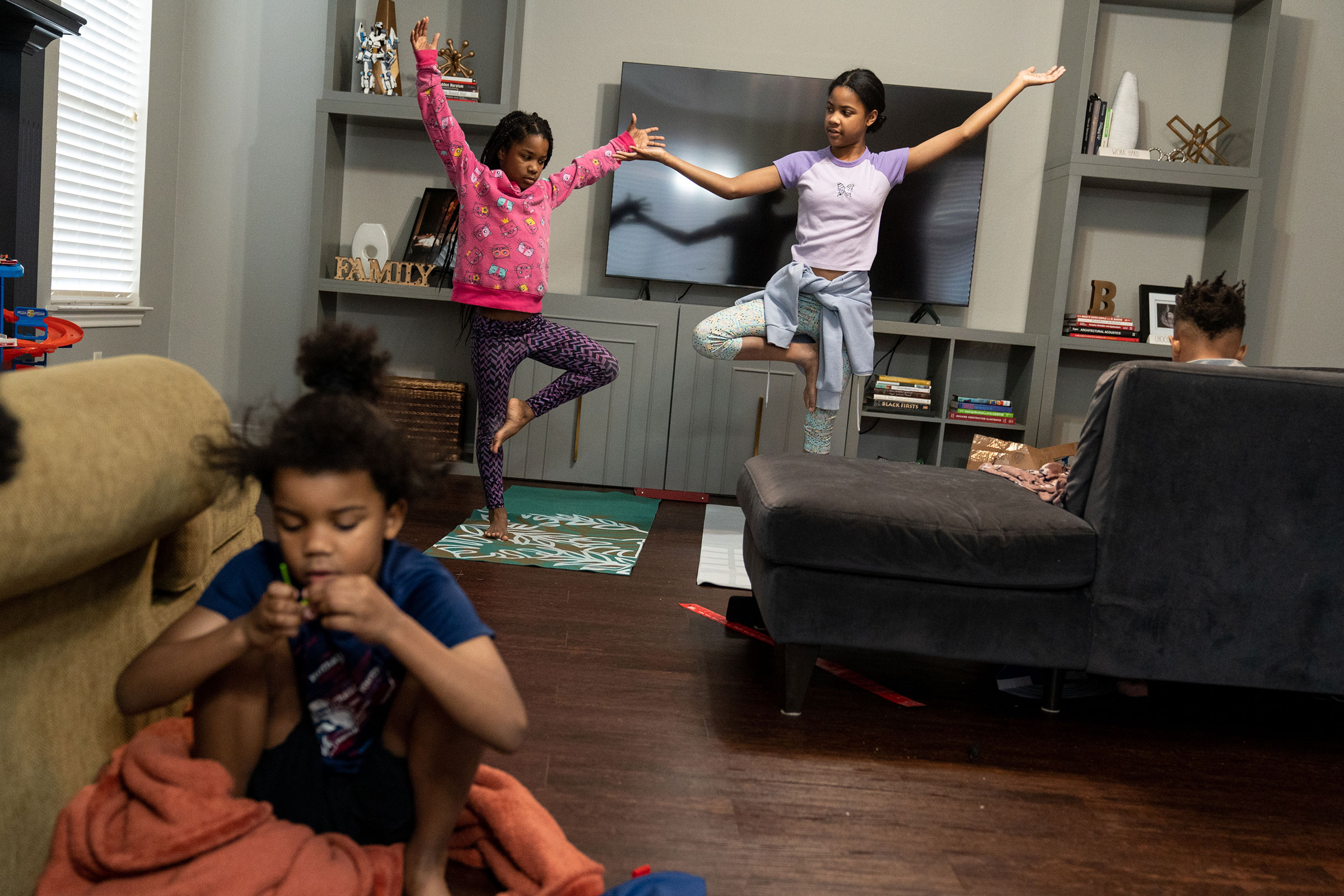 RICHARDSON, TEXAS - February 23, 2022: Bellamy, 8, and Brea, 12, do yoga in the living room. Ilana Panich-Linsman for TIME