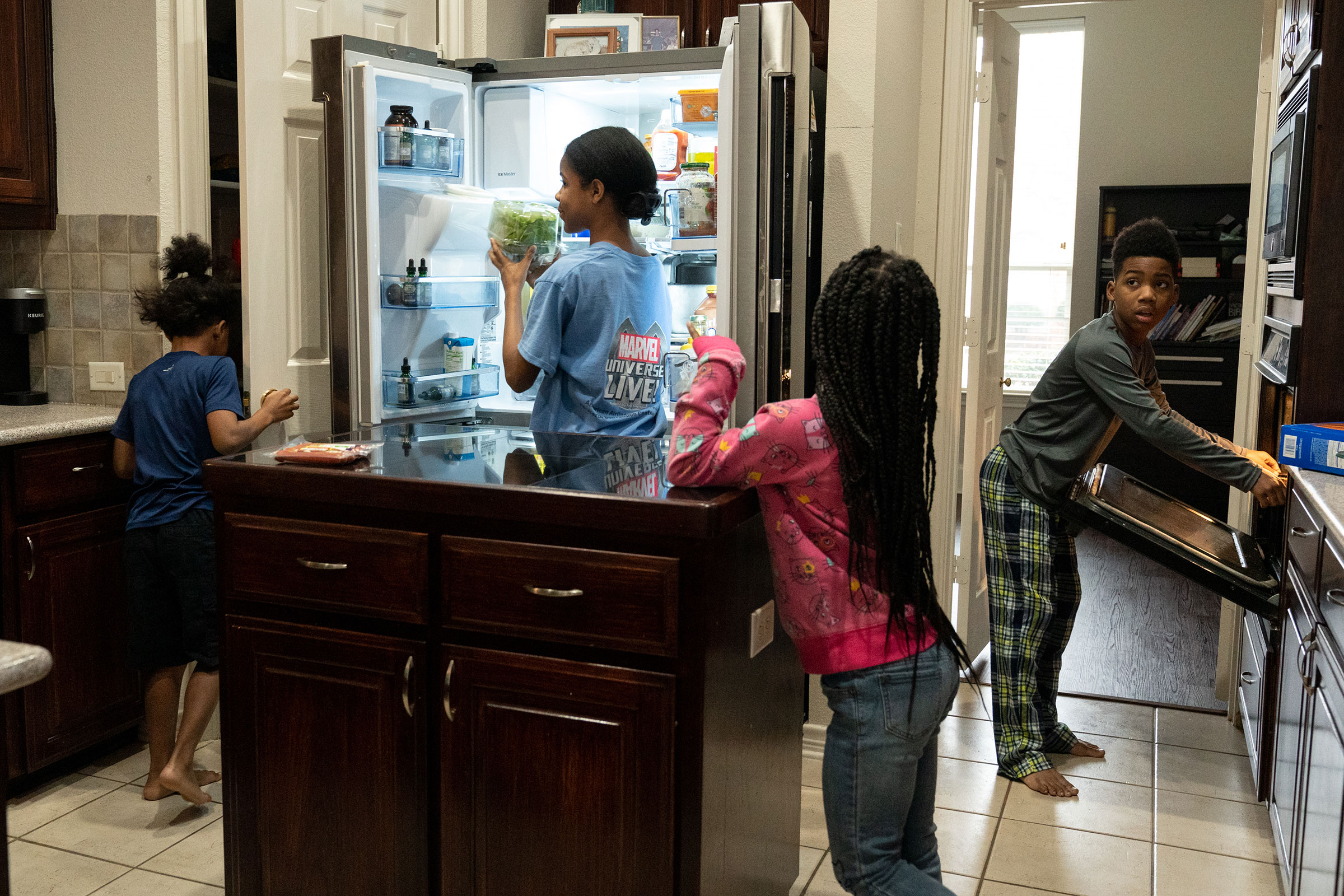 RICHARDSON, TEXAS - February 23, 2022: Four of the Thomas siblings make lunch after school lessons in the family's kitchen. Ilana Panich-Linsman for TIME