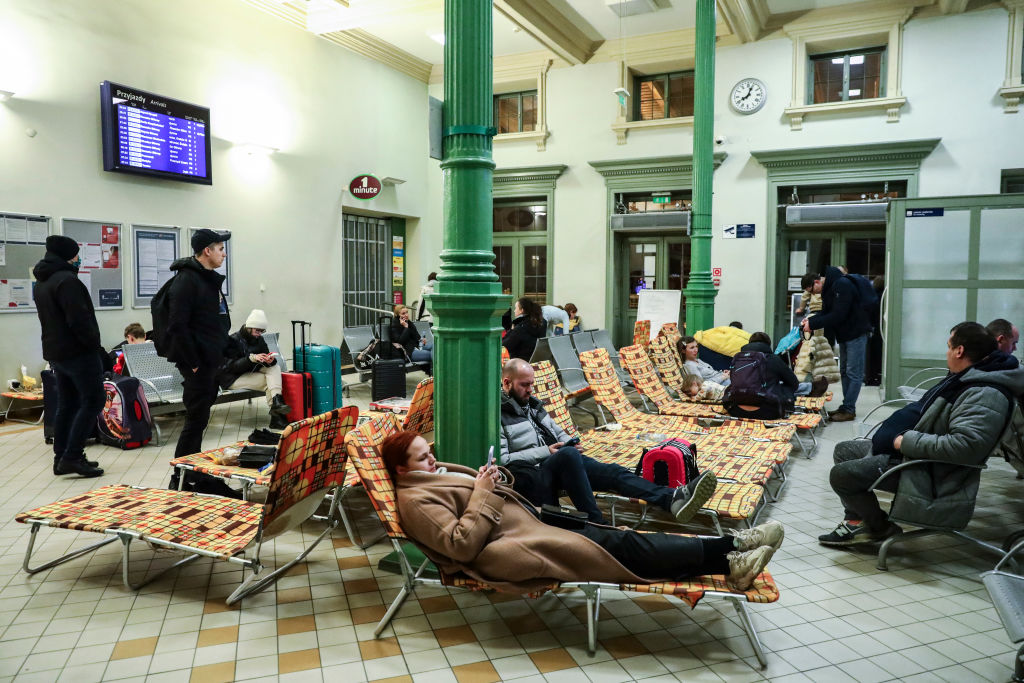 Passengers rest on camp beds in a temporary shelter inside a building of the railway station after arriving on a train from Kiev in Ukraine to Przemysl, Poland on February 24, 2022. (Beata Zawrzel—NurPhoto/Getty Images)
