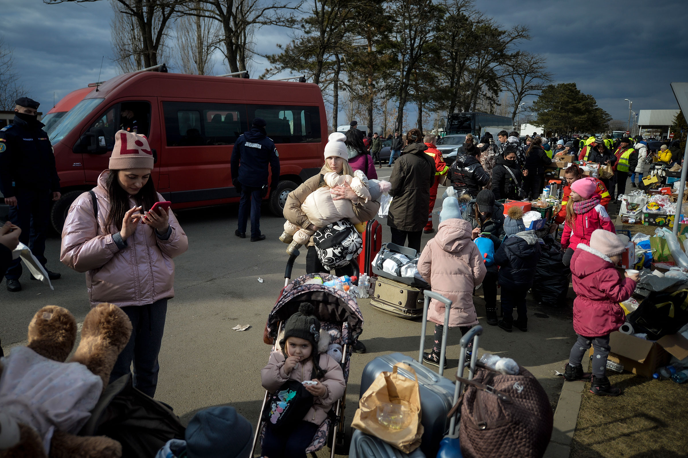 Refugees that fled the conflict from neighboring Ukraine, await for transportation at the Romanian-Ukrainian border, in Siret, Romania, on Feb. 27, 2022.