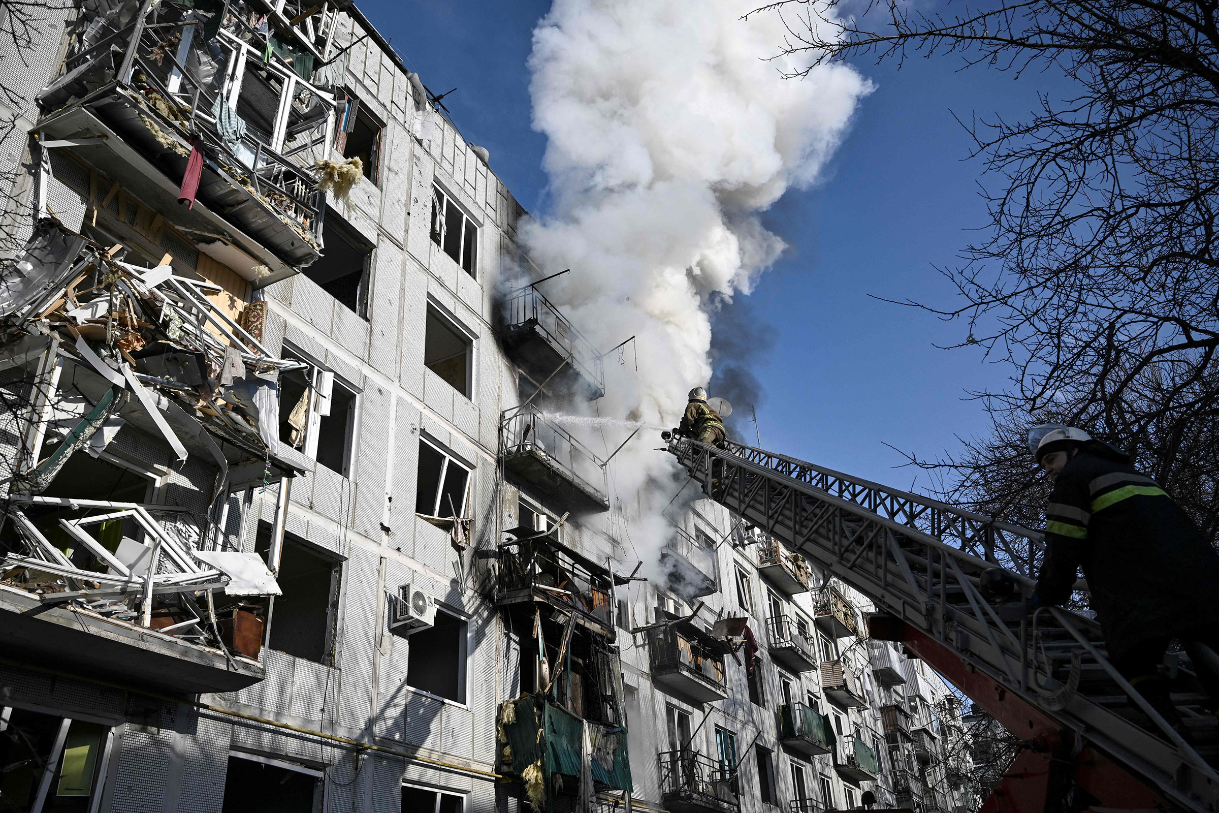 Firefighters work on a building fire after bombings on the eastern Ukraine town of Chuhuiv on Feb. 24, 2022.