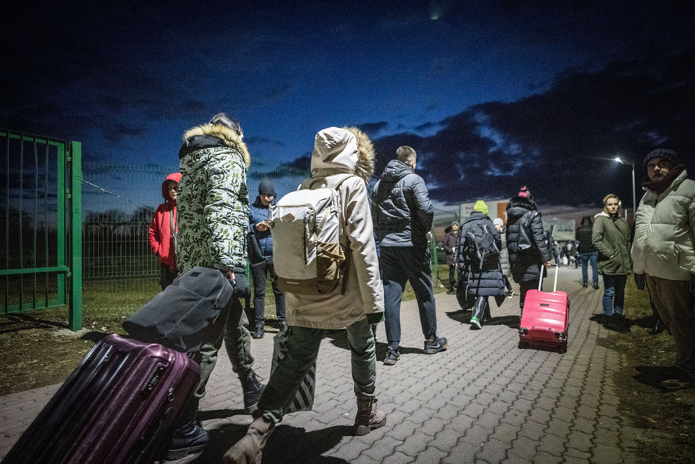 Refugees from Ukraine arrive in Medyka, Poland after crossing the border from Shehyni, Ukraine on Feb. 25, 2022. (Michael Kappeler—picture-allianc/AP)