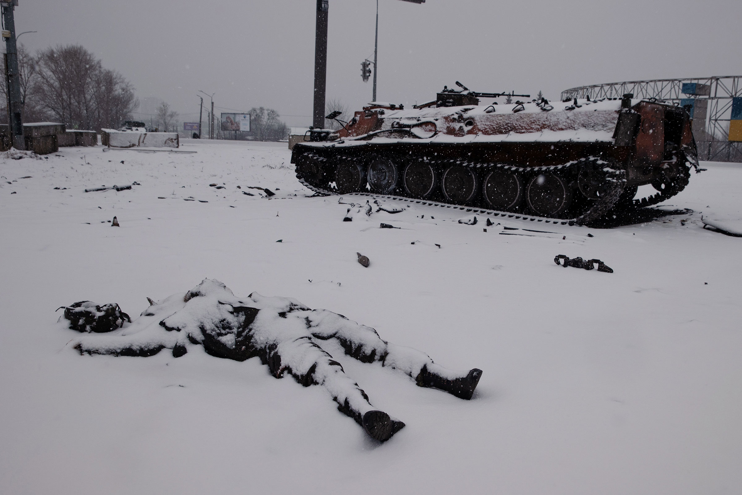 The body of a Russian soldier lies near destroyed Russian vehicles the day after fighting with Ukrainian soldiers on a highway outside Kharkiv, on Feb. 25.