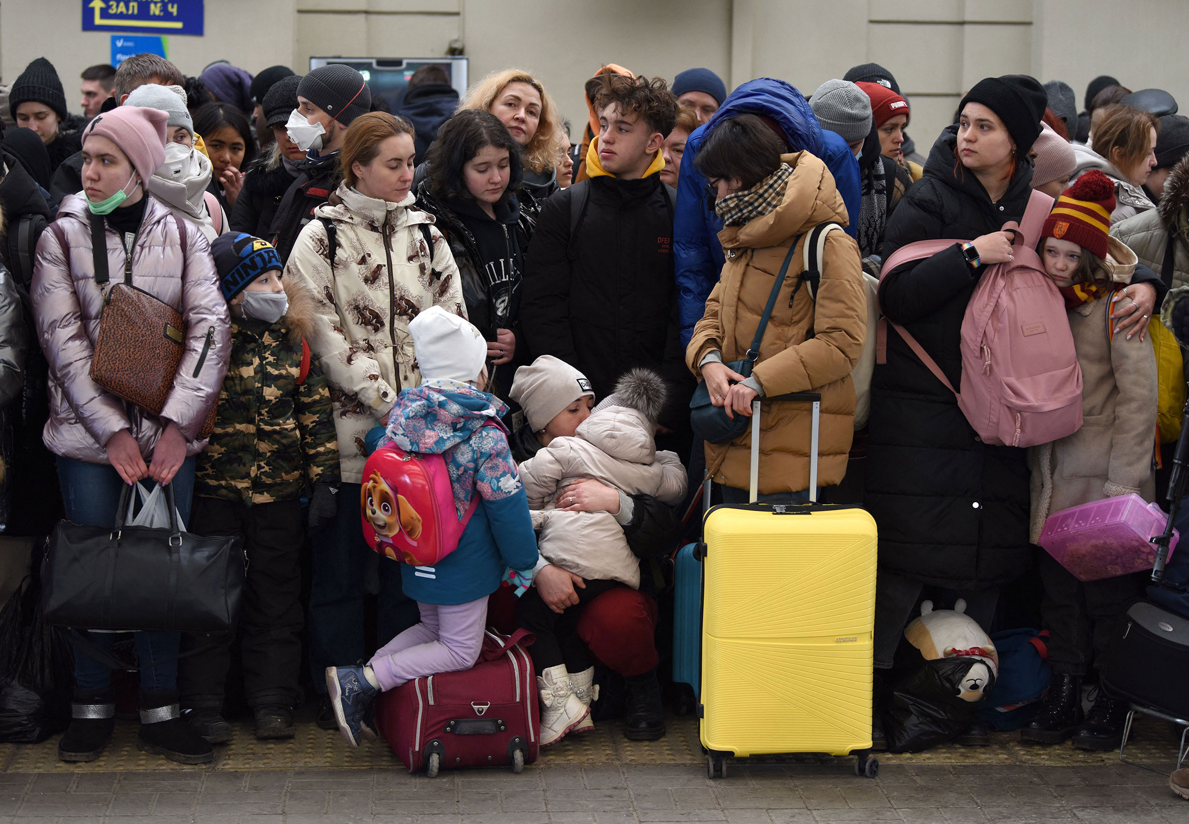 People wait for a train to Poland at the railway station of the western Ukrainian city of Lviv on Feb. 26.