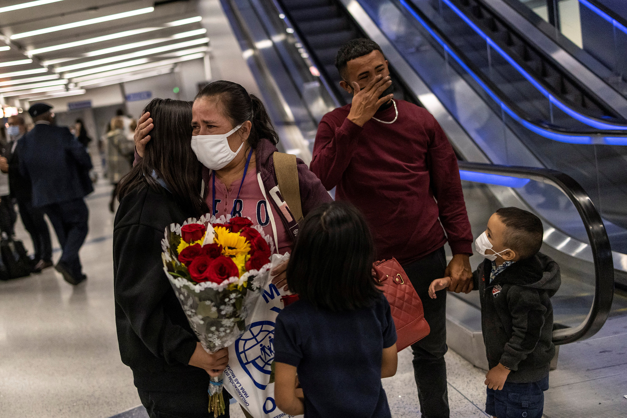 Maria Hernandez hugs her daughter Michelle, 12, (who is being referred to by her middle name to protect her privacy) during their family reunification at the Los Angeles International Airport on January 11, 2022. Hernandez was separated from her daughters and deported to Honduras under the Trump Administration's Zero Tolerance policy in 2017. (Carlos Barria—Reuters)