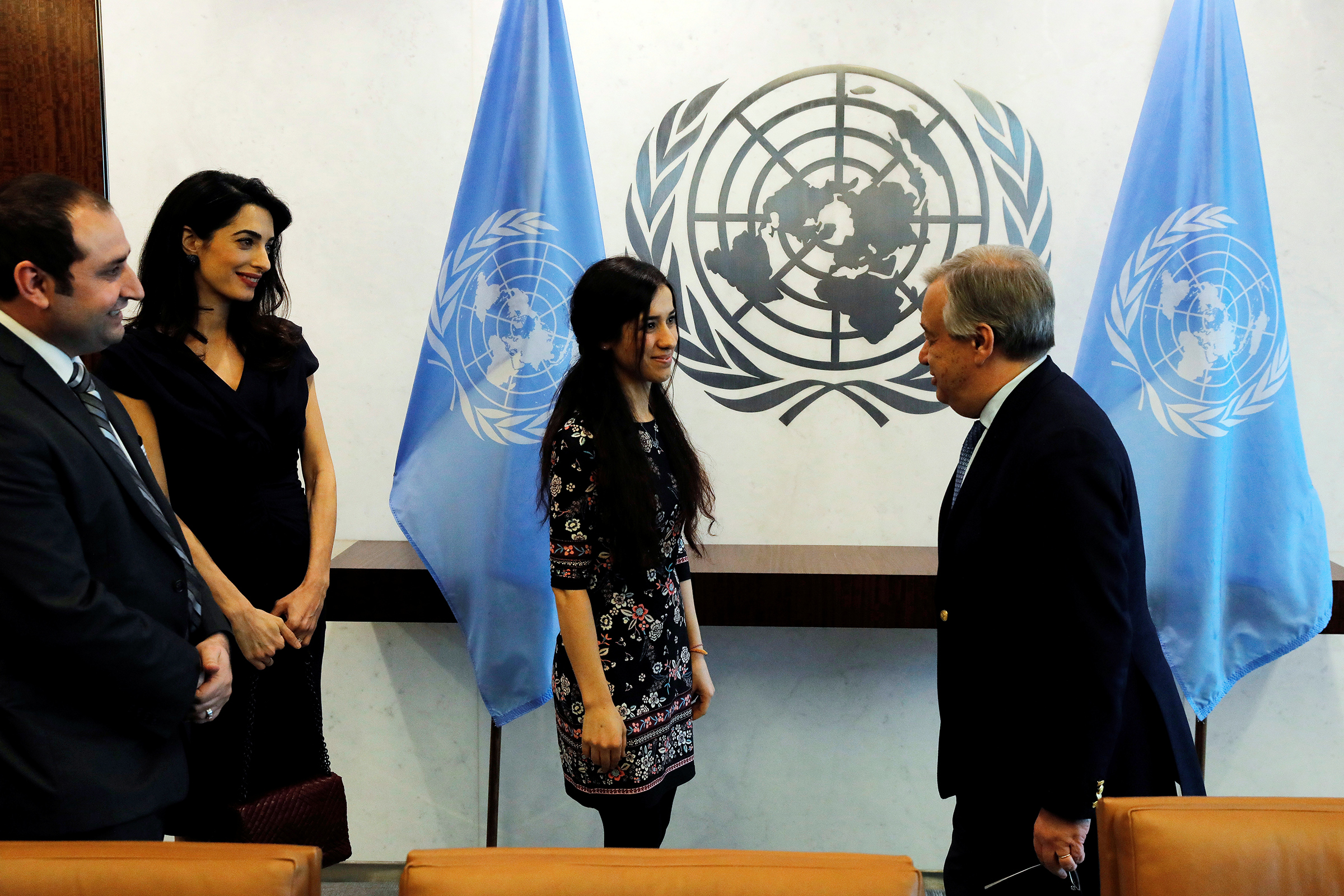 Clooney arrives at U.N. headquarters with Yezidi survivor Nadia Murad in March 2017 (Lucas Jackson—Reuters)