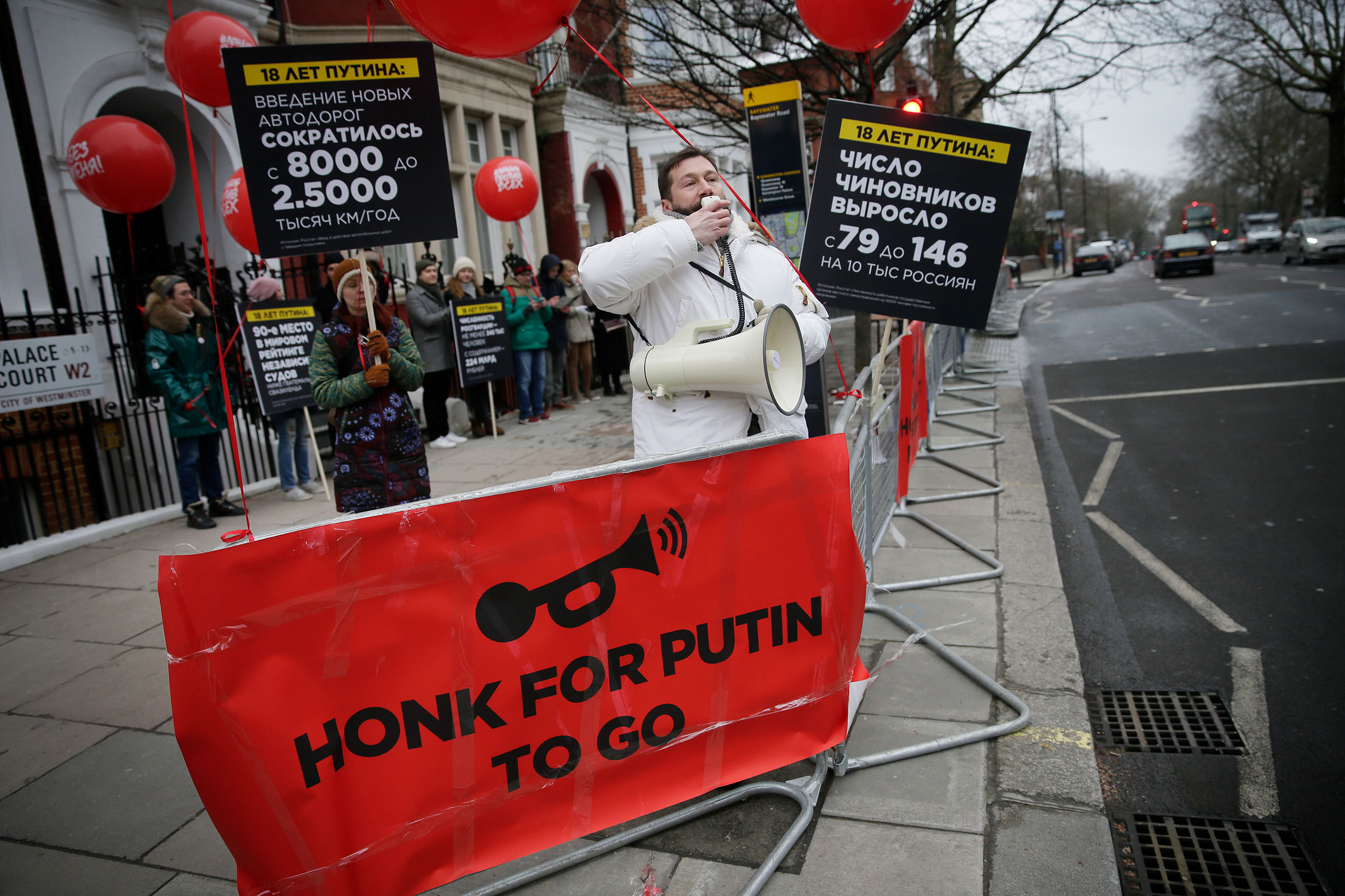 Chichvarkin speaks into a megaphone as he joins demonstrators opposing the Russian presidential election process outside the Russian Embassy in Kensington, London on March 18, 2018. (Tim Ireland—AP)